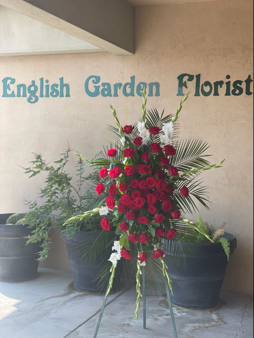Standing floral spray of red roses and white gladiolus