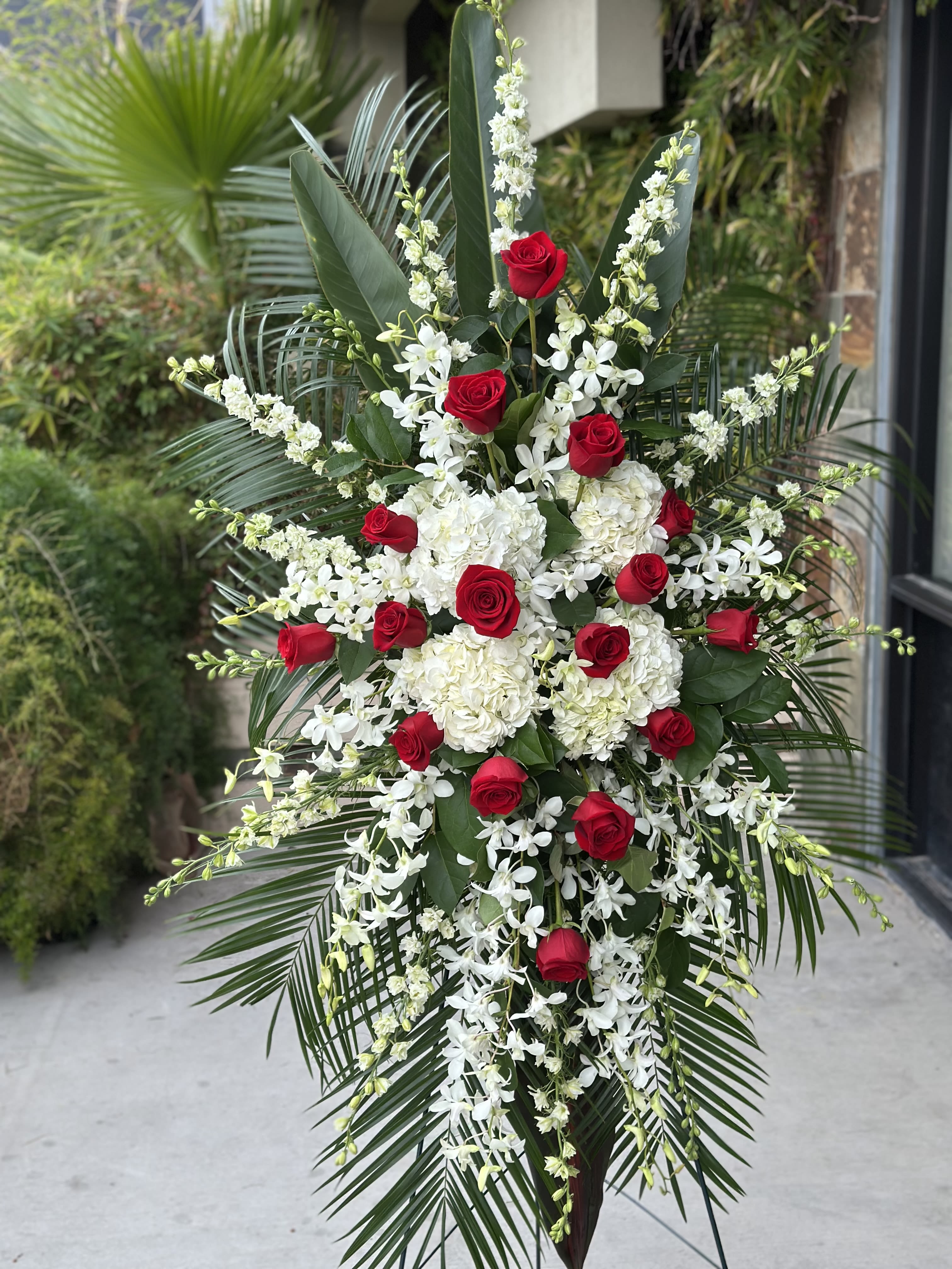 Tall floral spray with red roses and white flowers