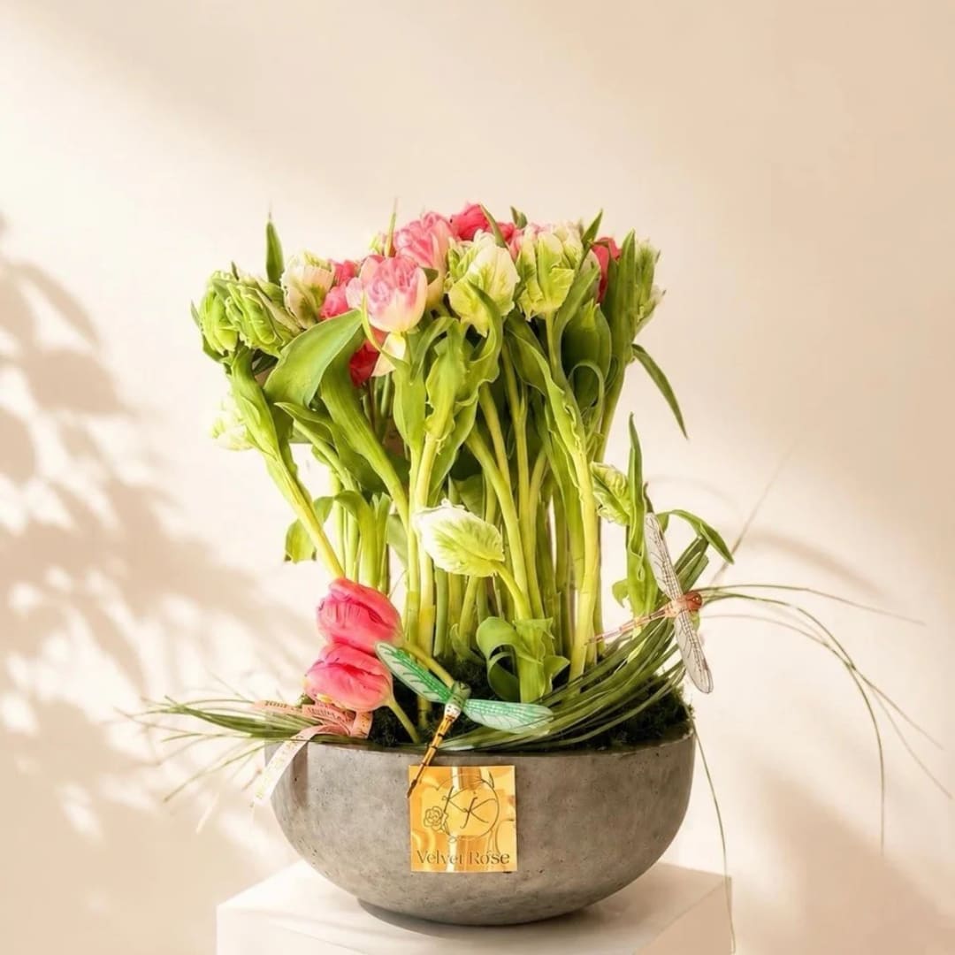 Pink and green floral arrangement in a round gray bowl