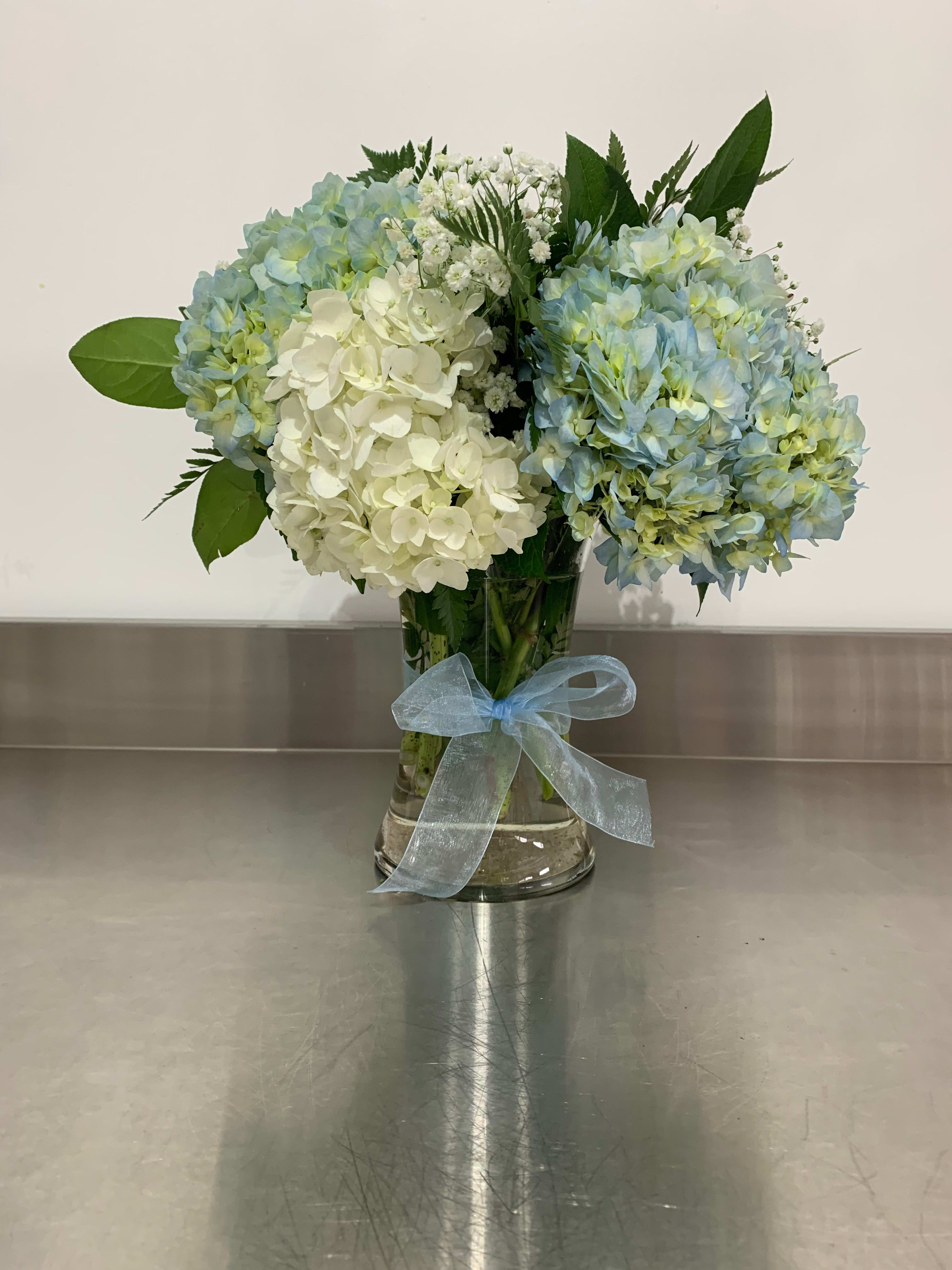 Heaven Sent - A fresh arrangement for a baby boy, made with fluffy hydrangea.  