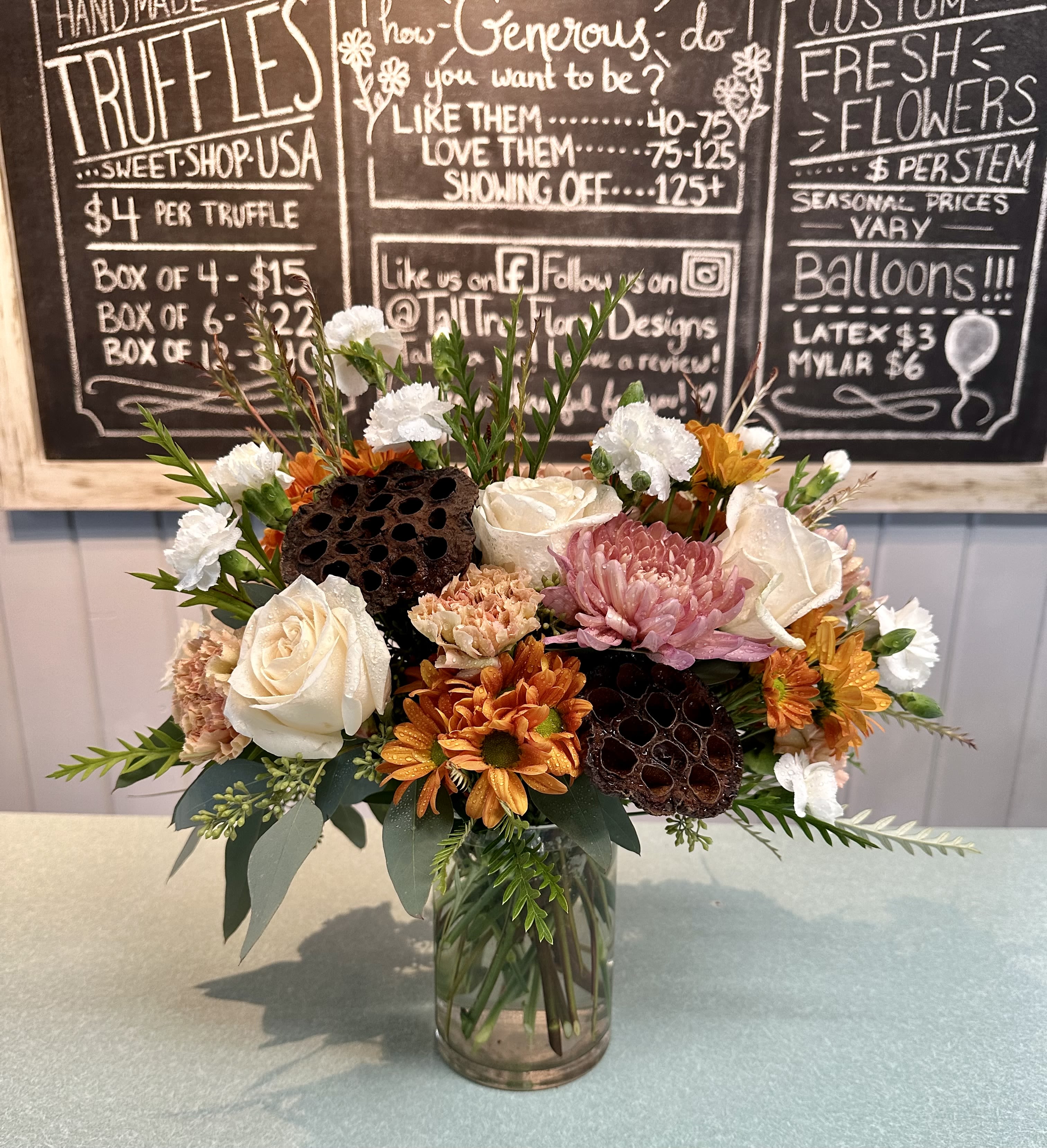 Pumpkin Chai - Lynette peach cremones, vendela ivory roses, butterscotch daisy's, white mini carnations, antique pink carnation and grevellia with brown pods in a clear glass cylinder