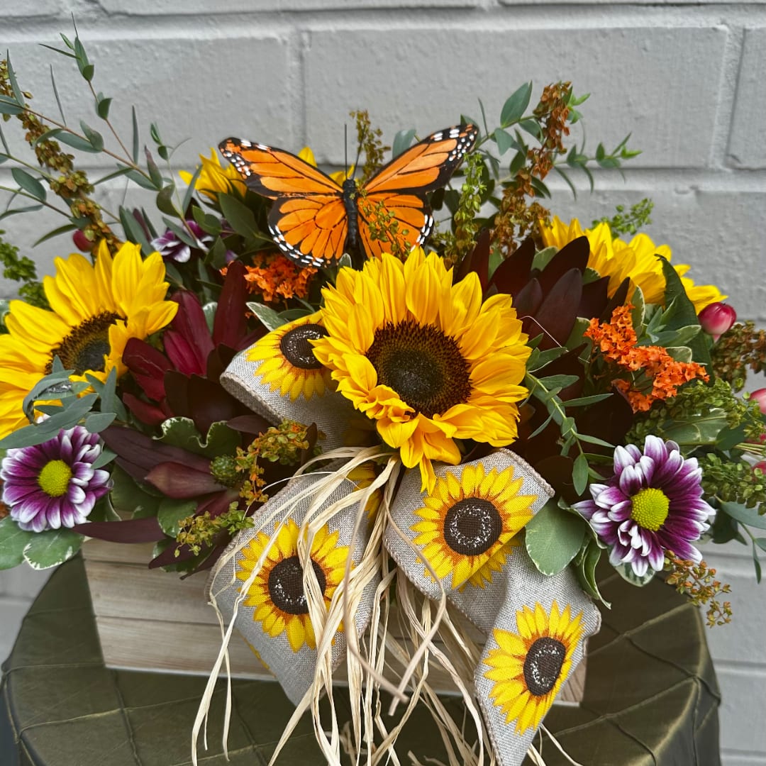 Sunflower bouquet with purple daisies and a butterfly topper