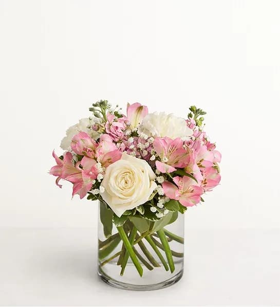 Pink and white bouquet in a clear glass vase