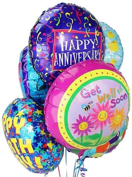 Cluster of colorful foil balloons with happy birthday and happy anniversary messages