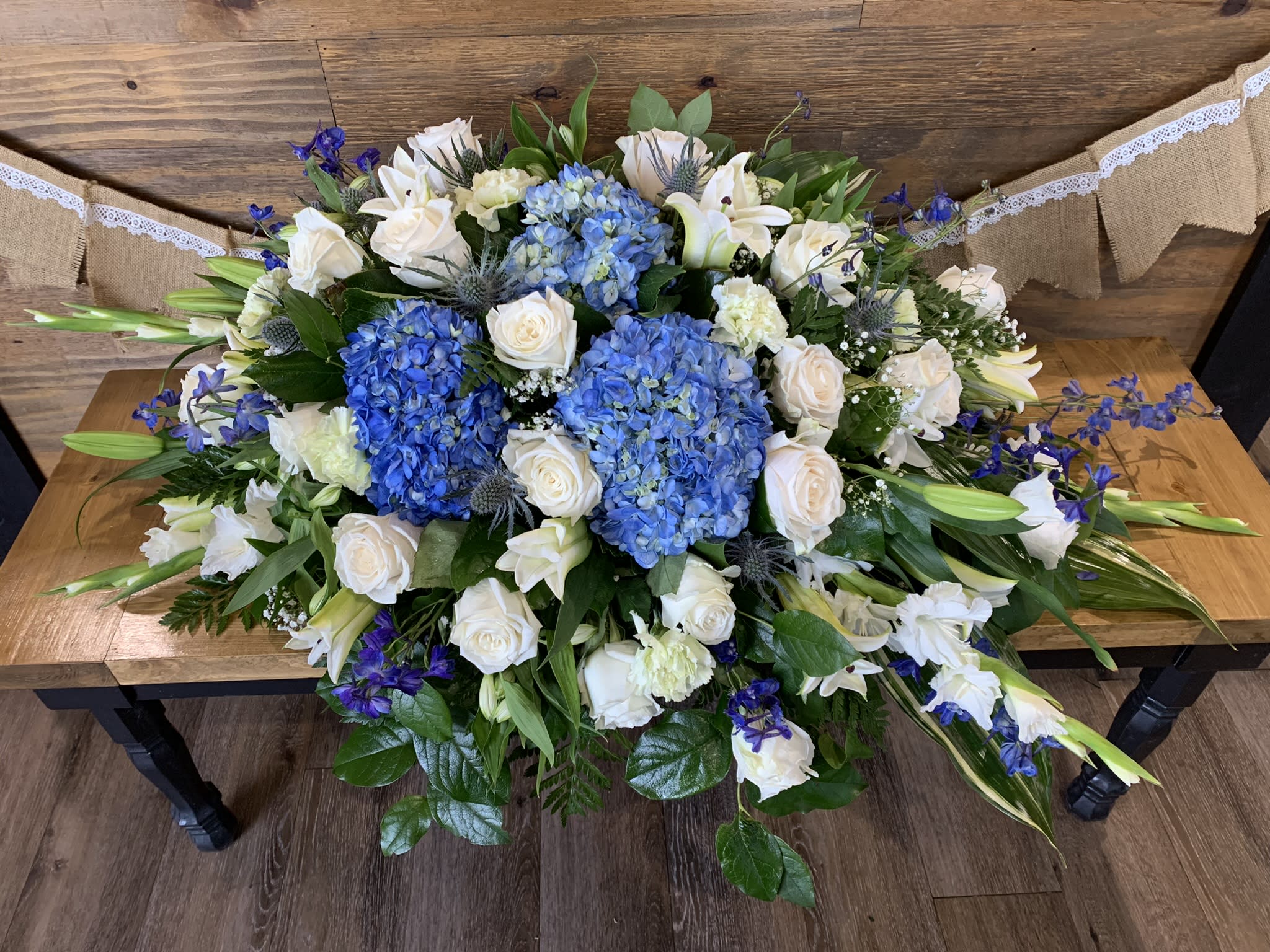 Blue Skies - Blue and white casket spray.