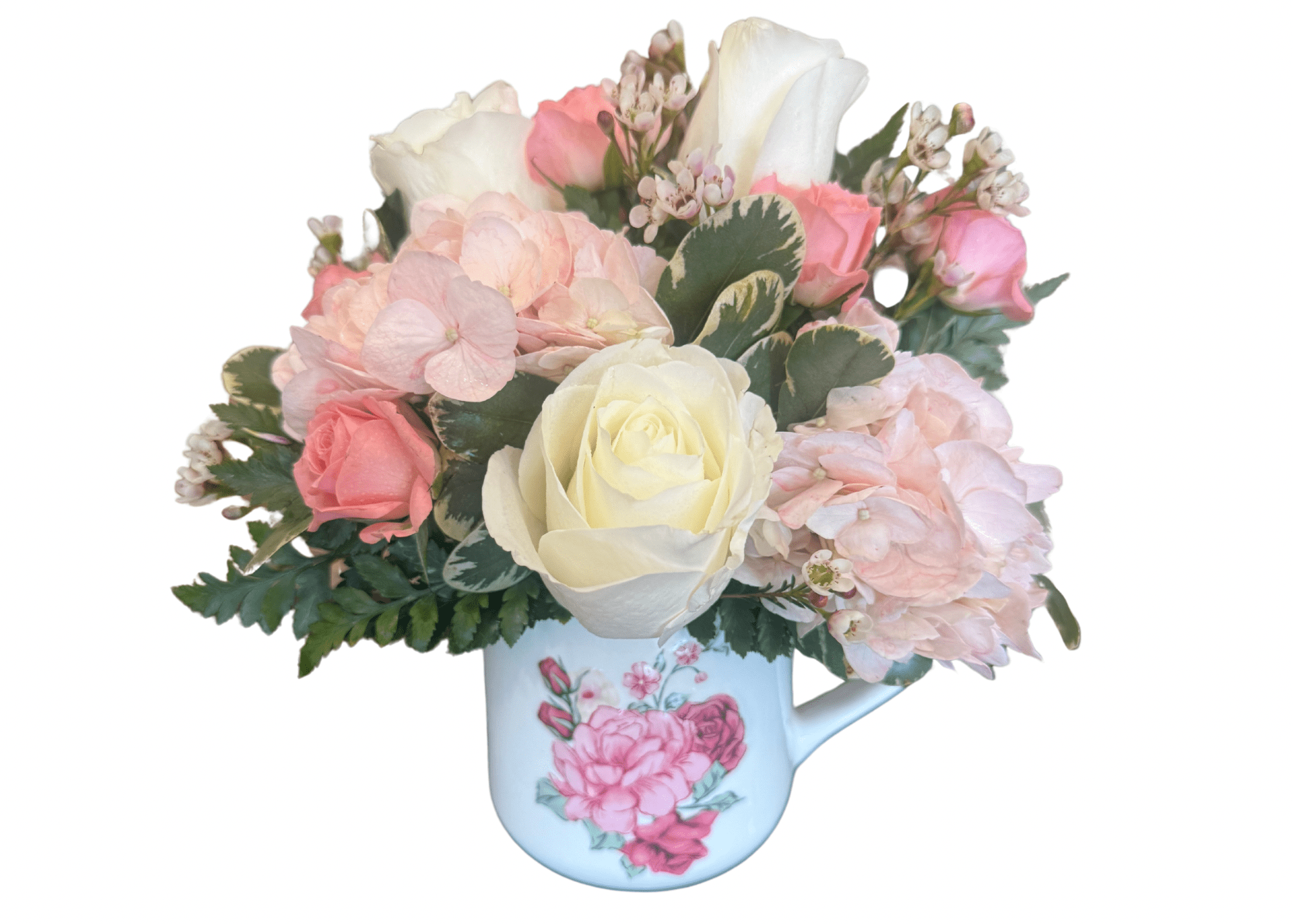 Pink and white roses with hydrangeas in a floral mug