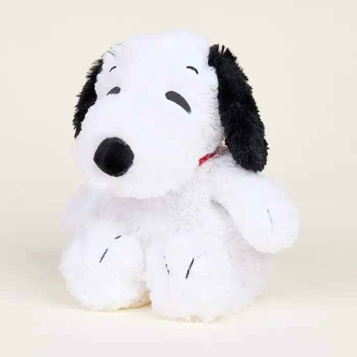Plush Snoopy stuffed animal with black ears on a plain background