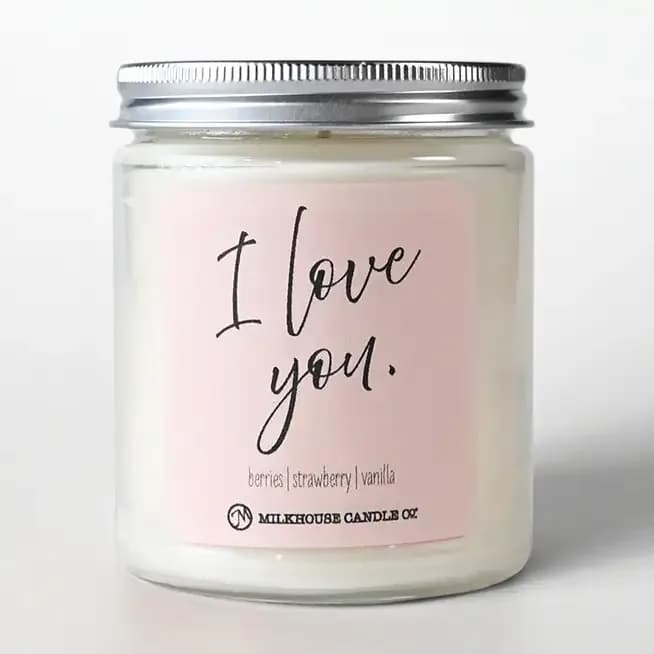 Pink candle in a glass jar with a metal lid and "I love you" label