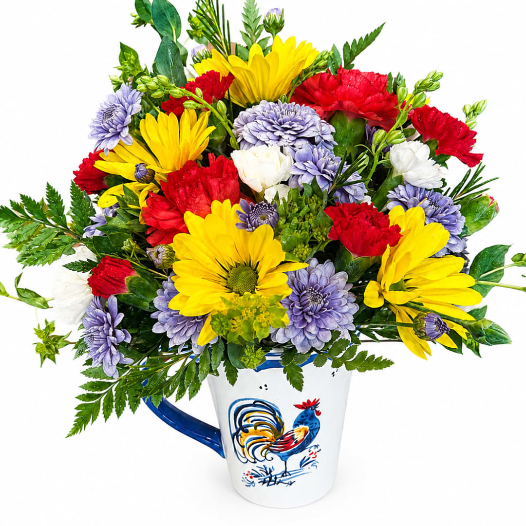 Colorful bouquet of daisies and carnations in a white mug with a rooster design