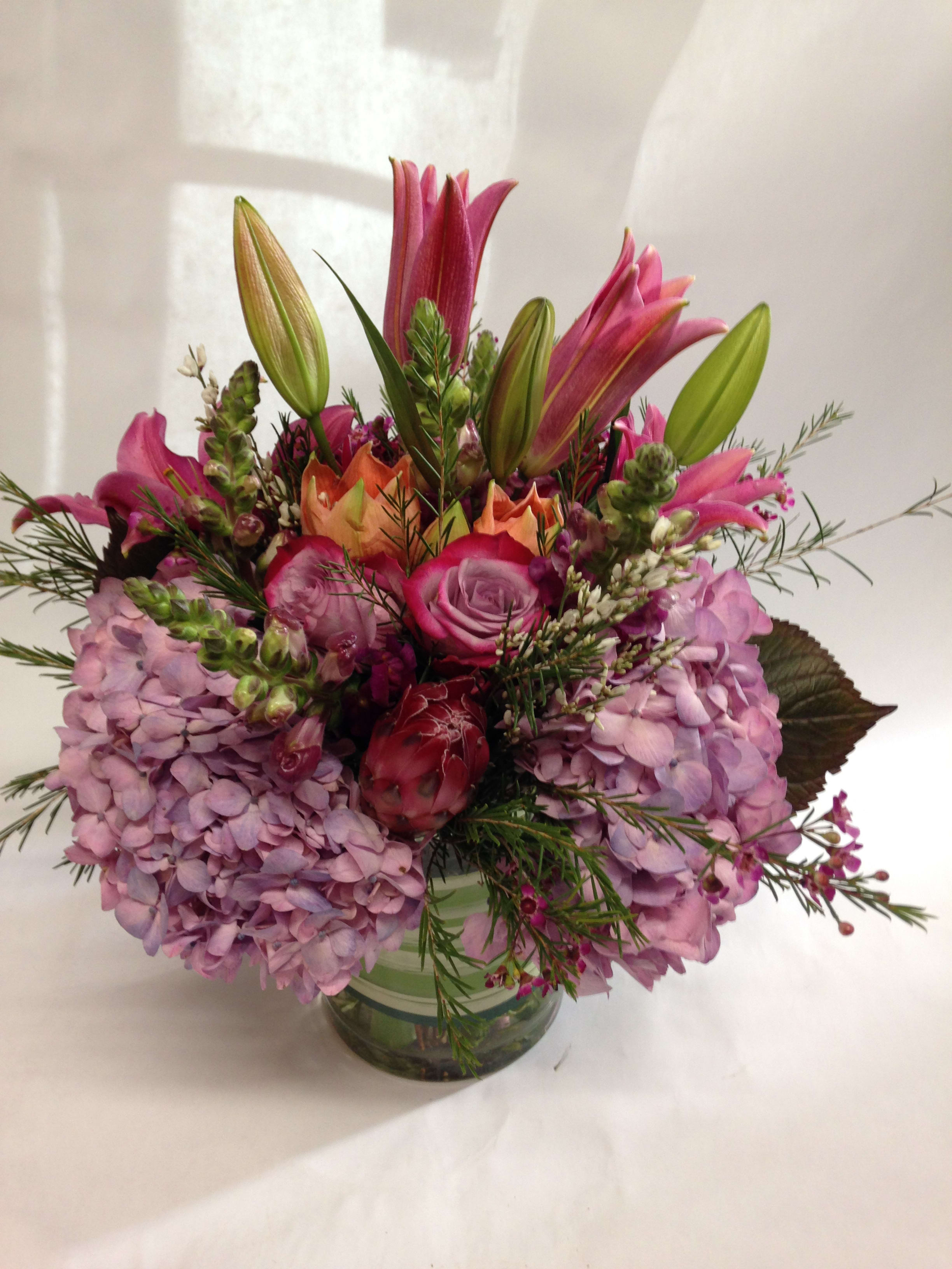 Pink and lavender floral arrangement in a glass vase