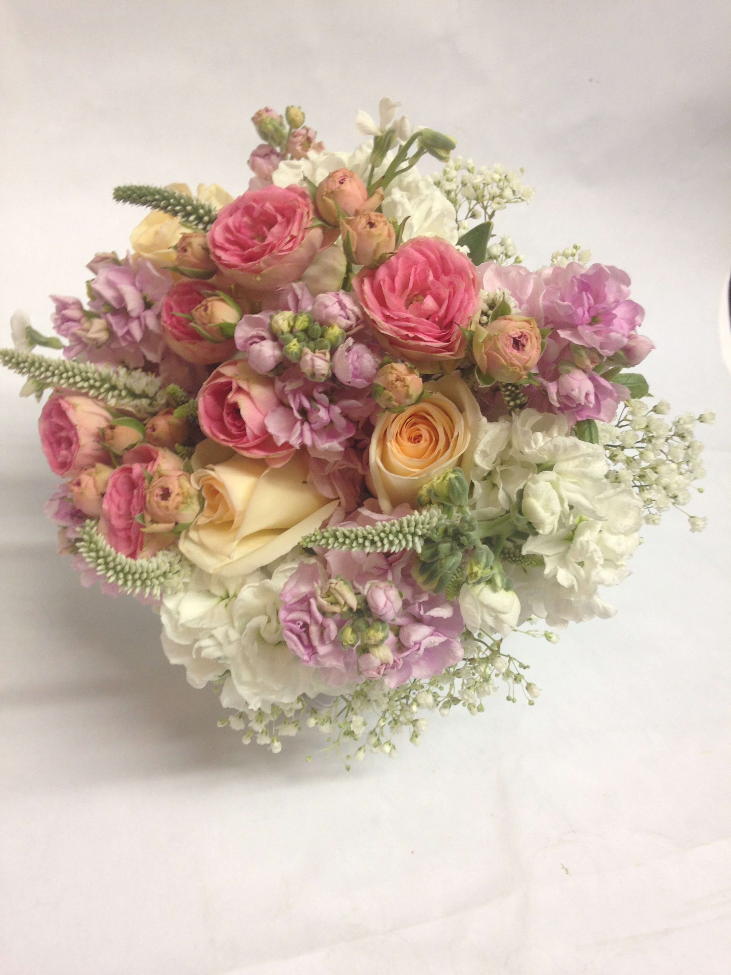 Bouquet of pink and cream roses with white filler flowers