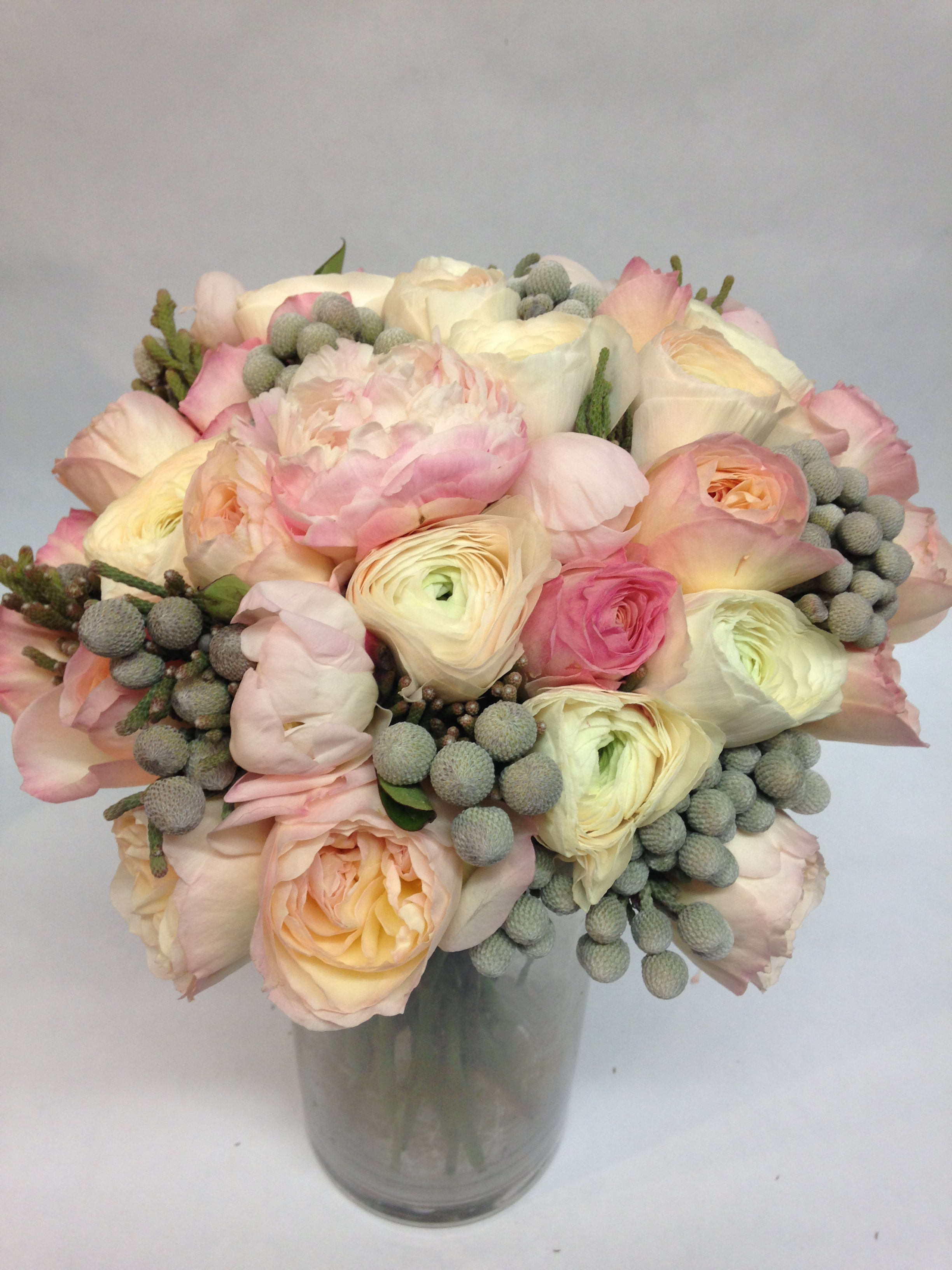 Bouquet of pale pink and cream flowers in a glass vase