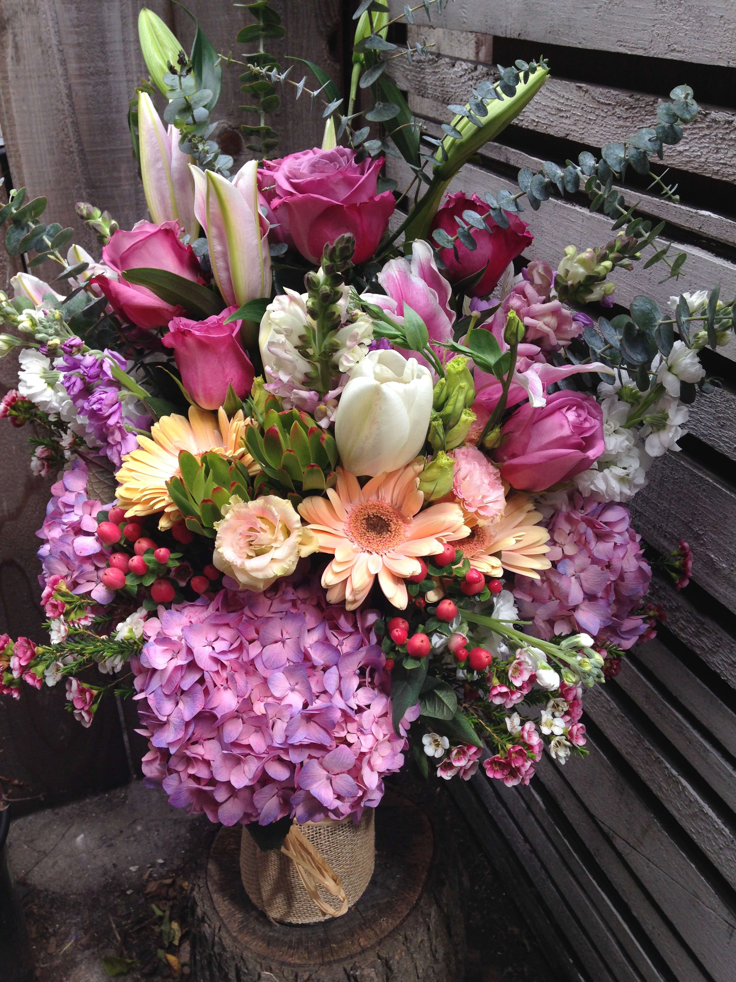 Mixed bouquet with pink roses, lilies, hydrangeas, and gerbera daisies