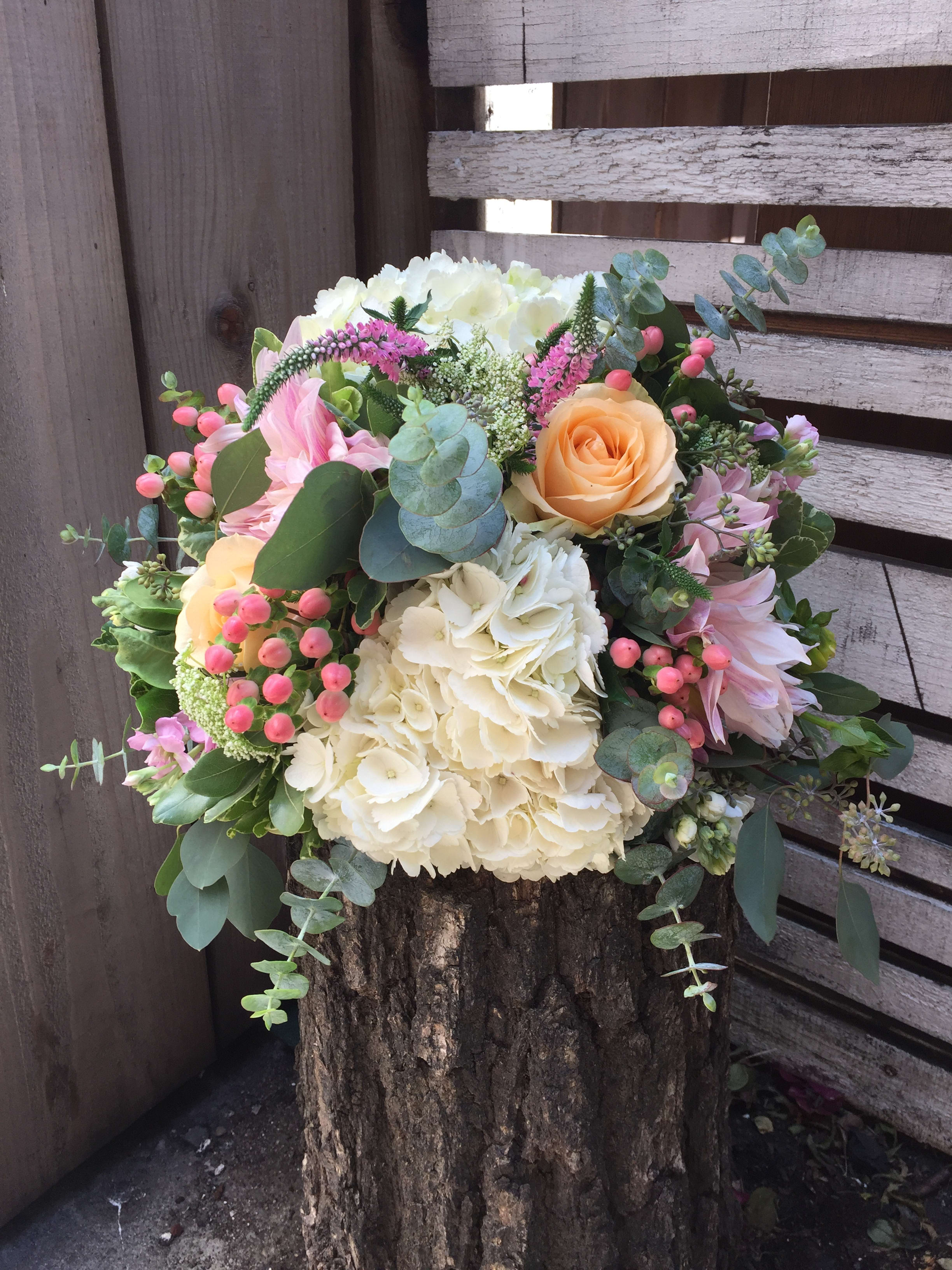 Mixed bouquet with cream hydrangeas, peach roses, and pink flowers