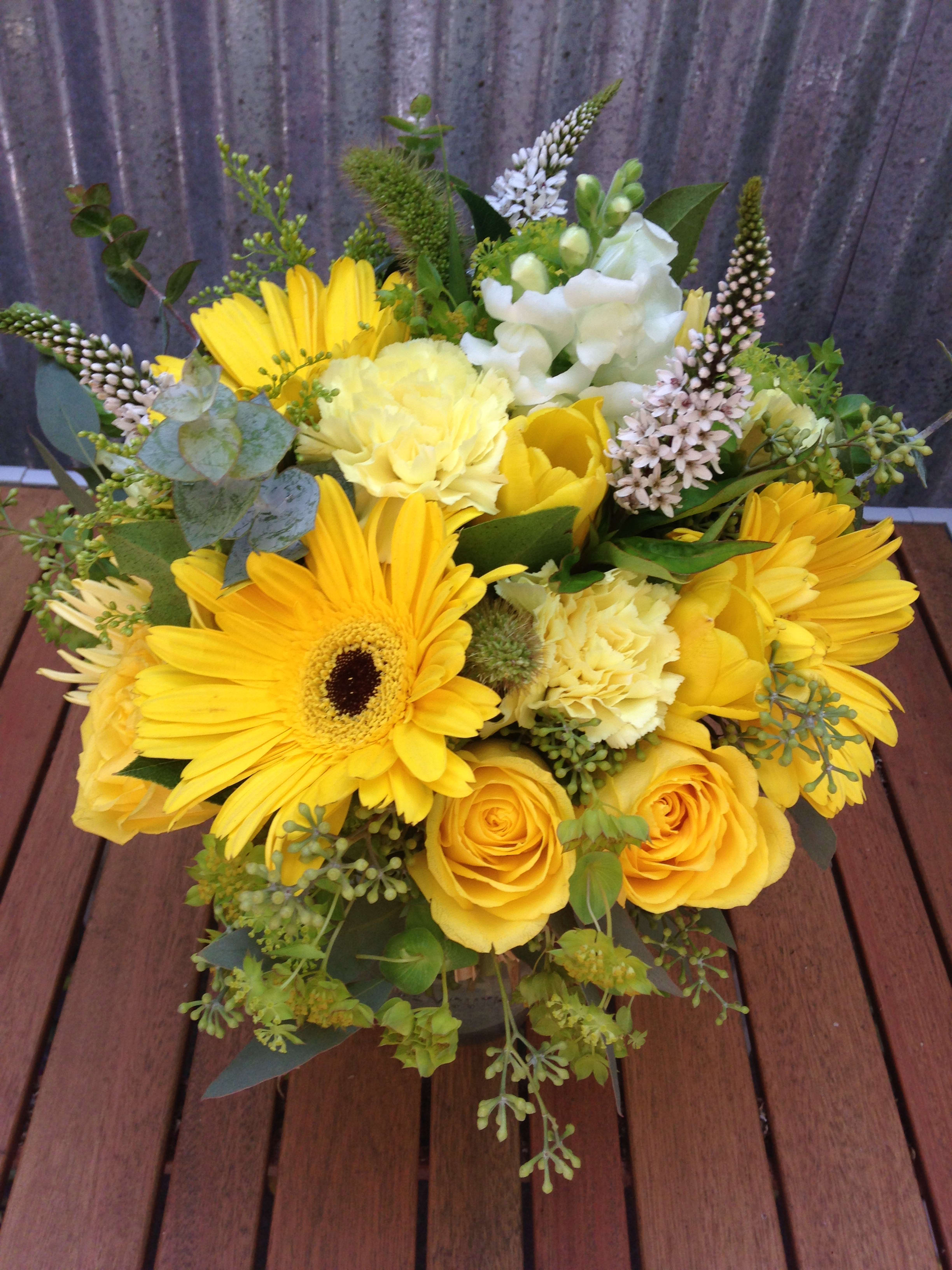 Yellow bouquet with gerbera daisies and roses in a low arrangement