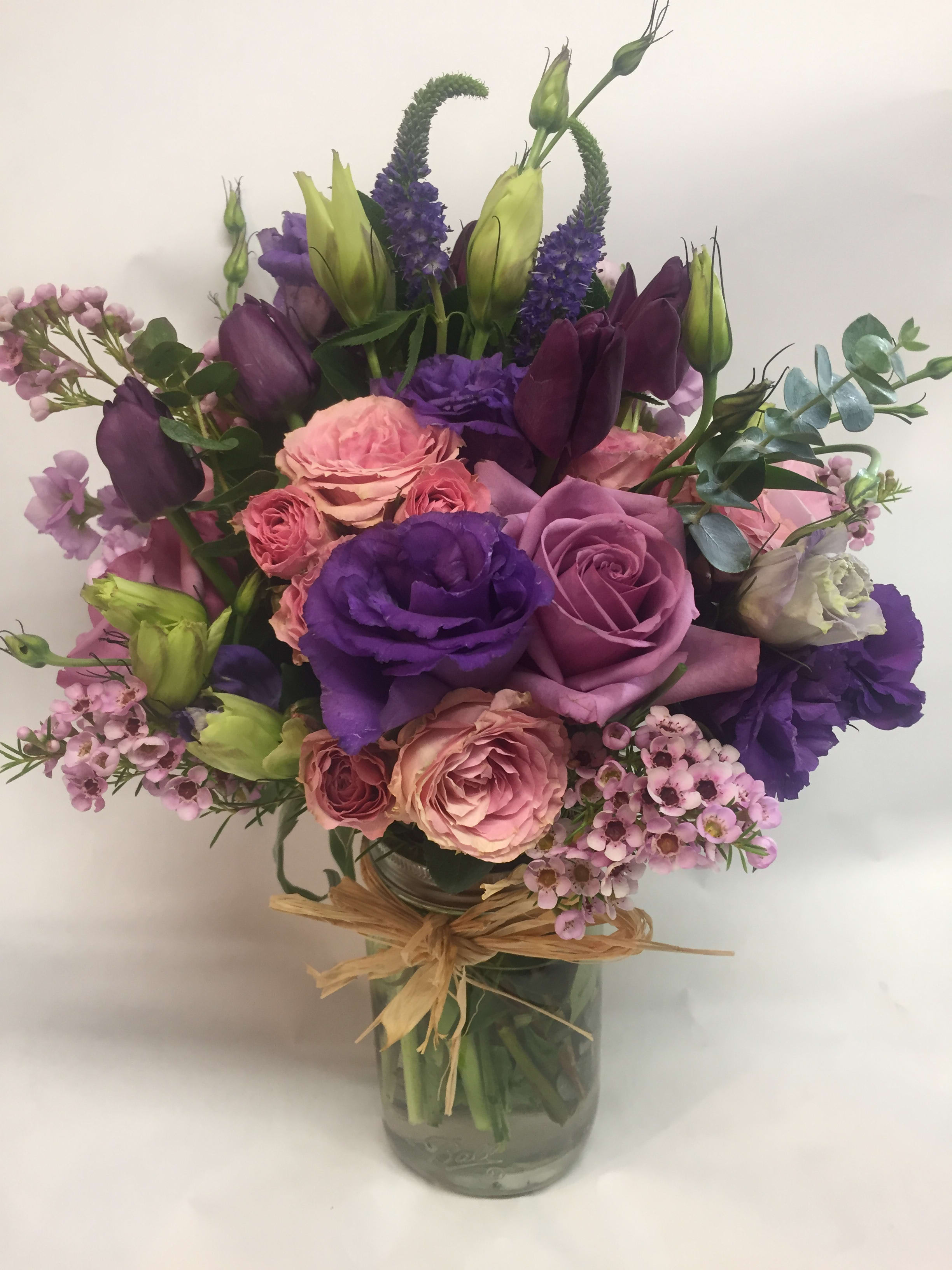 Purple and pink mixed bouquet in a glass vase