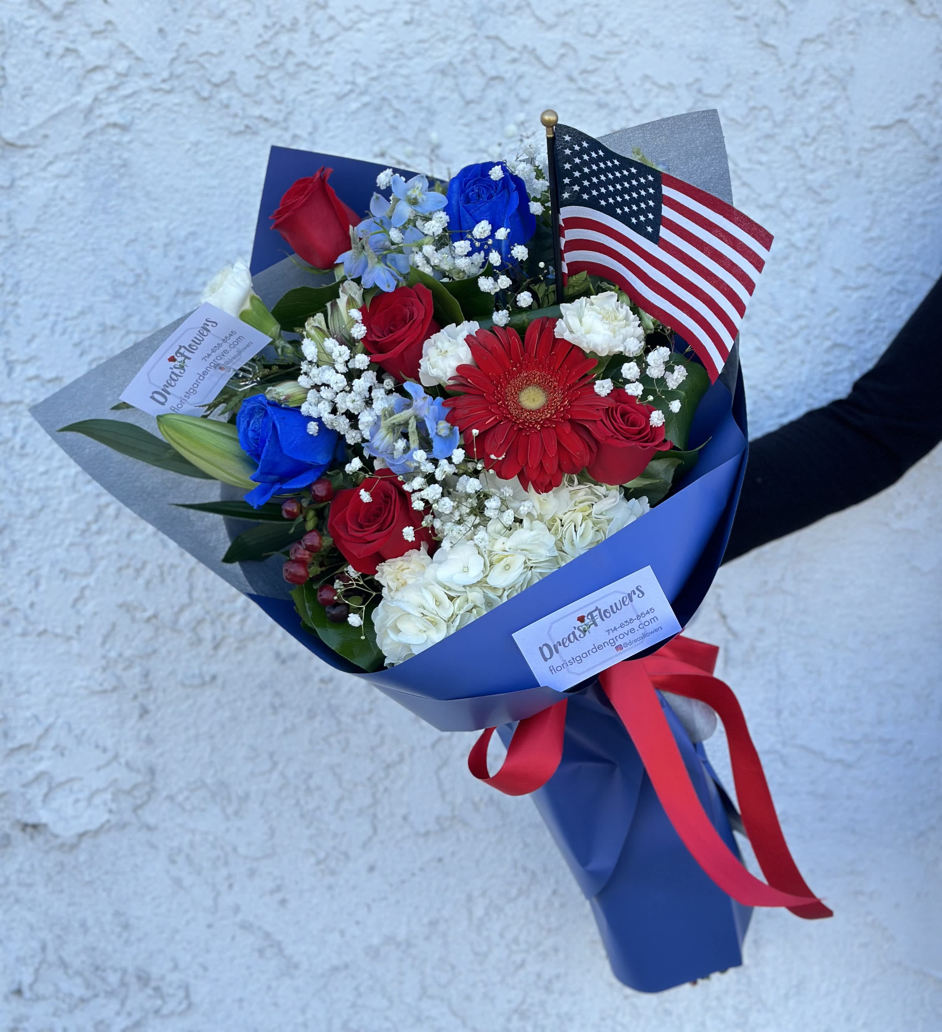 Bouquet of red, white, and blue flowers with an American flag