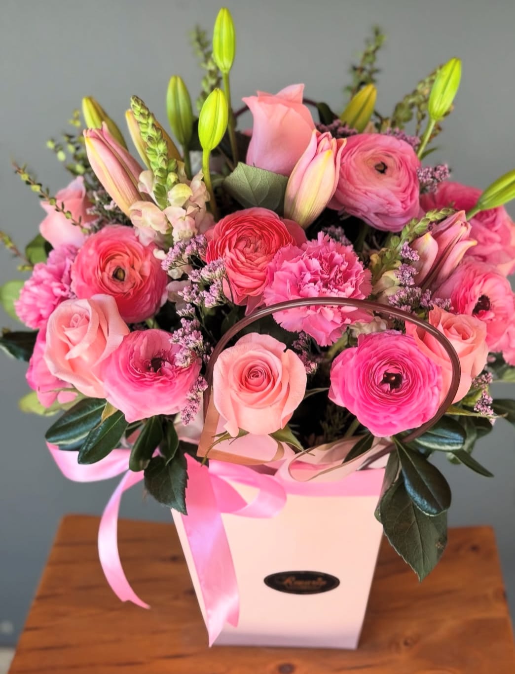 Pink mixed bouquet in a white gift box with a ribbon