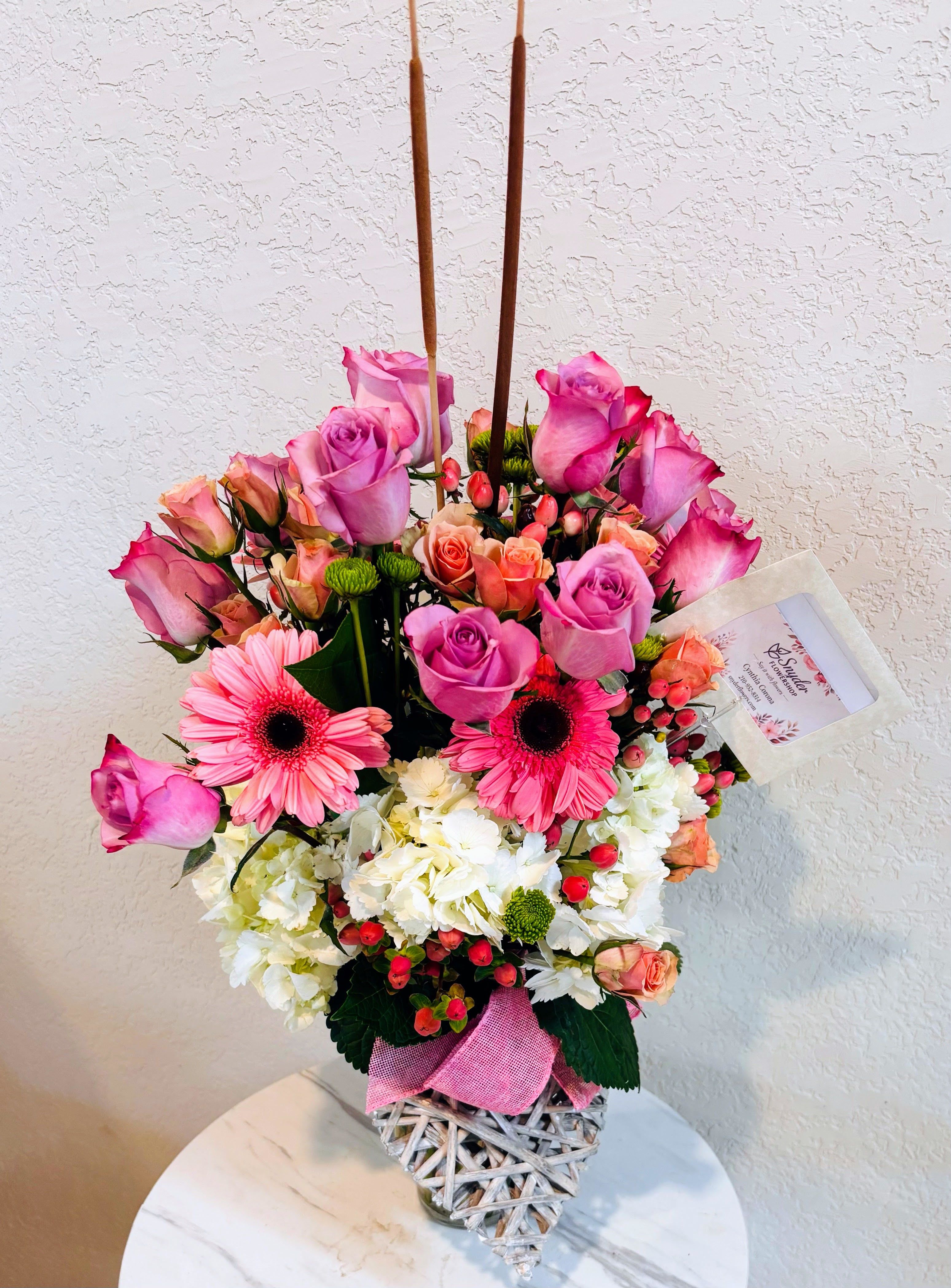 Enchanted Blush Heart | Pink &amp; Lavender Rose Luxury Arrangement -  Celebrate love, beauty and unforgettable moments with our Enchanted Blush Heart | Pink &amp; Lavender Rose Luxury Arrangement, exclusively handcrafted by Snyder Flowers. This elegant floral design features premium lavender roses, soft pink roses, peach spray roses, white hydrangeas, vibrant pink gerbera daisies, hypericum berries, button mums and lush seasonal greenery, artistically arranged in a charming heart-shaped keepsake basket.  Its romantic color palette and luxurious garden style make it an exceptional gift for anniversaries, Valentine's Day, birthdays, Mother's Day, engagements, bridal showers, congratulations, new baby celebrations, thank you gifts, thinking of you messages and romantic surprises. Every arrangement is designed with premium fresh flowers to create a stunning presentation and long-lasting beauty.  We proudly provide same-day flower delivery in San Antonio, serving Stone Oak, Alamo Heights, The Dominion, Shavano Park, Castle Hills, Medical Center, Helotes, Leon Valley, Schertz, Cibolo, Live Oak, Universal City, Boerne, Bulverde, Timberwood Park and surrounding communities.  If you're searching for pink roses, lavender roses, romantic flower arrangements, luxury flower baskets, Valentine's Day flowers, anniversary flowers, birthday flowers, flower delivery in San Antonio or the best florist near you, Snyder Flowers creates handcrafted floral gifts that make every celebration unforgettable.