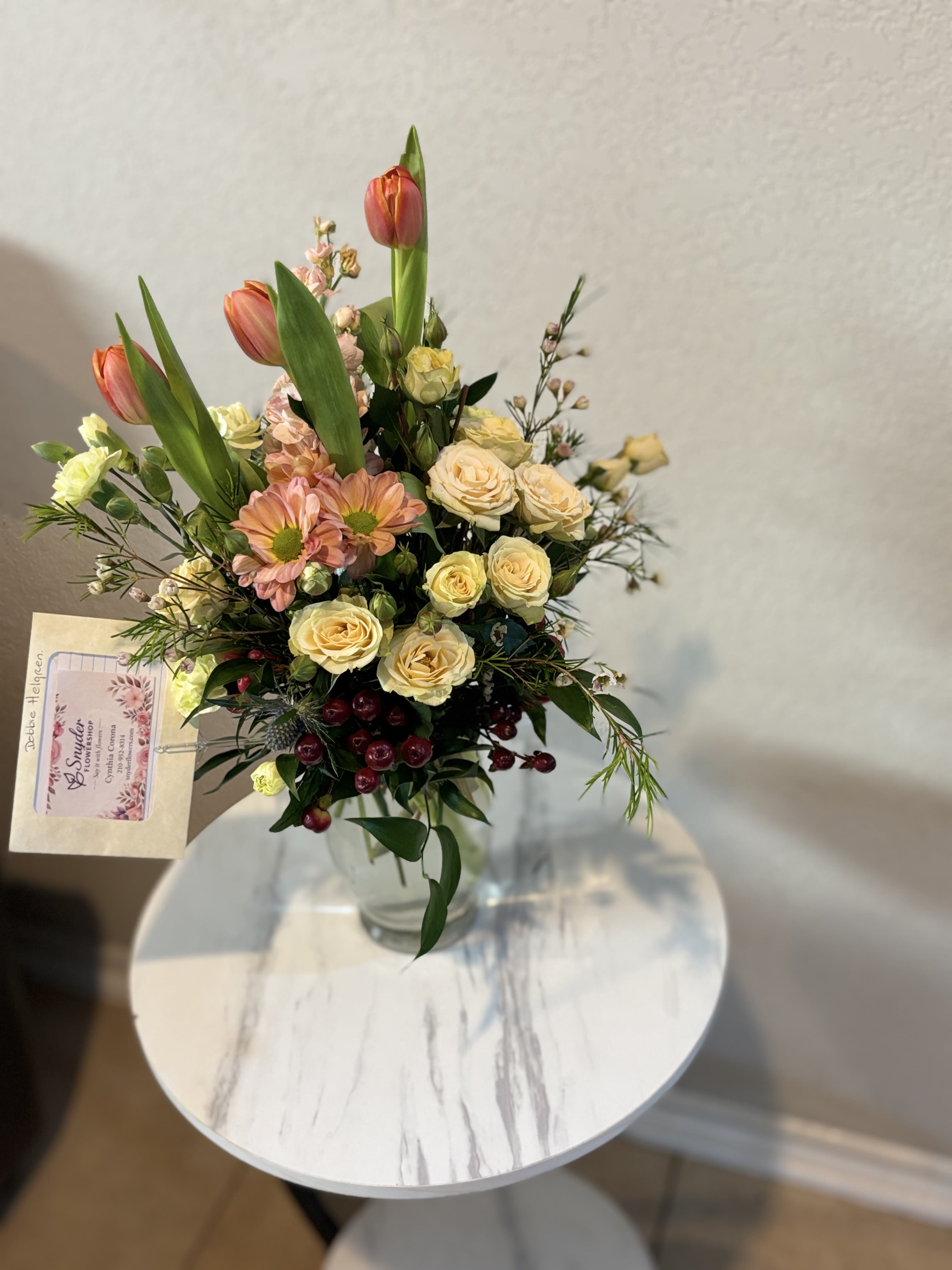 Spring Garden Elegance | Tulips &amp; Spray Roses Vase Arrangement - Celebrate life's most meaningful moments with our Patriotic Elegance | Red &amp; White Rose Luxury Arrangement, exclusively handcrafted by Snyder Flowers. This sophisticated floral design features premium long-stem red roses and elegant white roses, beautifully accented with silver dusty miller and lush seasonal greenery in a modern keepsake wooden container.  The timeless combination of red and white roses symbolizes love, admiration, respect and new beginnings, making this arrangement an exceptional choice for anniversaries, birthdays, sympathy services, funeral flowers, memorial tributes, congratulations, thank you gifts, corporate gifts, housewarming celebrations, Valentine's Day, Mother's Day and romantic surprises.  Each arrangement is handcrafted using premium fresh flowers and is available with same-day flower delivery in San Antonio, including Stone Oak, Alamo Heights, The Dominion, Shavano Park, Castle Hills, Medical Center, Helotes, Leon Valley, Schertz, Cibolo, Live Oak, Universal City, Boerne, Timberwood Park, Bulverde and surrounding communities.  If you're searching for red roses, white roses, rose arrangements, sympathy flowers, anniversary flowers, luxury flower delivery, same-day flower delivery or a trusted florist in San Antonio, Snyder Flowers creates elegant floral gifts designed with exceptional quality, freshness and attention to detail.