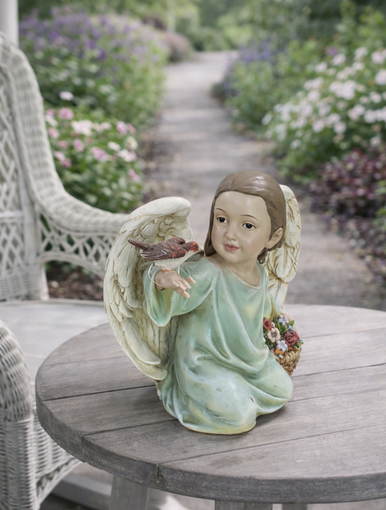 7.5” Songbird Angel Figurine - The Songbird Angel is a beautiful keepsake that celebrates hope, comfort, faith, and meaningful connections. Featuring a graceful 7.5 inch angel gently interacting with a delicate songbird, this charming figurine symbolizes peace, encouragement, friendship, and the simple reminders that brighten life’s journey.  Its soft colors and timeless design make it a lovely addition to bookshelves, mantels, desks, bedside tables, display cabinets, and special keepsake collections. Whether given as a thoughtful gift or displayed in your own home, the Songbird Angel brings warmth and inspiration to any space.  The Standard version includes the angel figurine accented with a coordinating ribbon. Deluxe and Premium versions pair the figurine with fresh flowers selected to complement the angel’s colors and gentle appearance. Premium designs feature additional blooms and enhanced texture for greater visual impact while maintaining an elegant presentation.  A thoughtful gift for birthdays, encouragement, thinking of you occasions, friendship gifts, thank you gifts, church members, teachers, caregivers, family, and friends. The Songbird Angel is also an appropriate keepsake for remembrance, sympathy, and honoring cherished memories.  Beautiful, uplifting, and timeless, this angel figurine offers a lasting expression of love, support, faith, and encouragement that can be treasured for years to come.