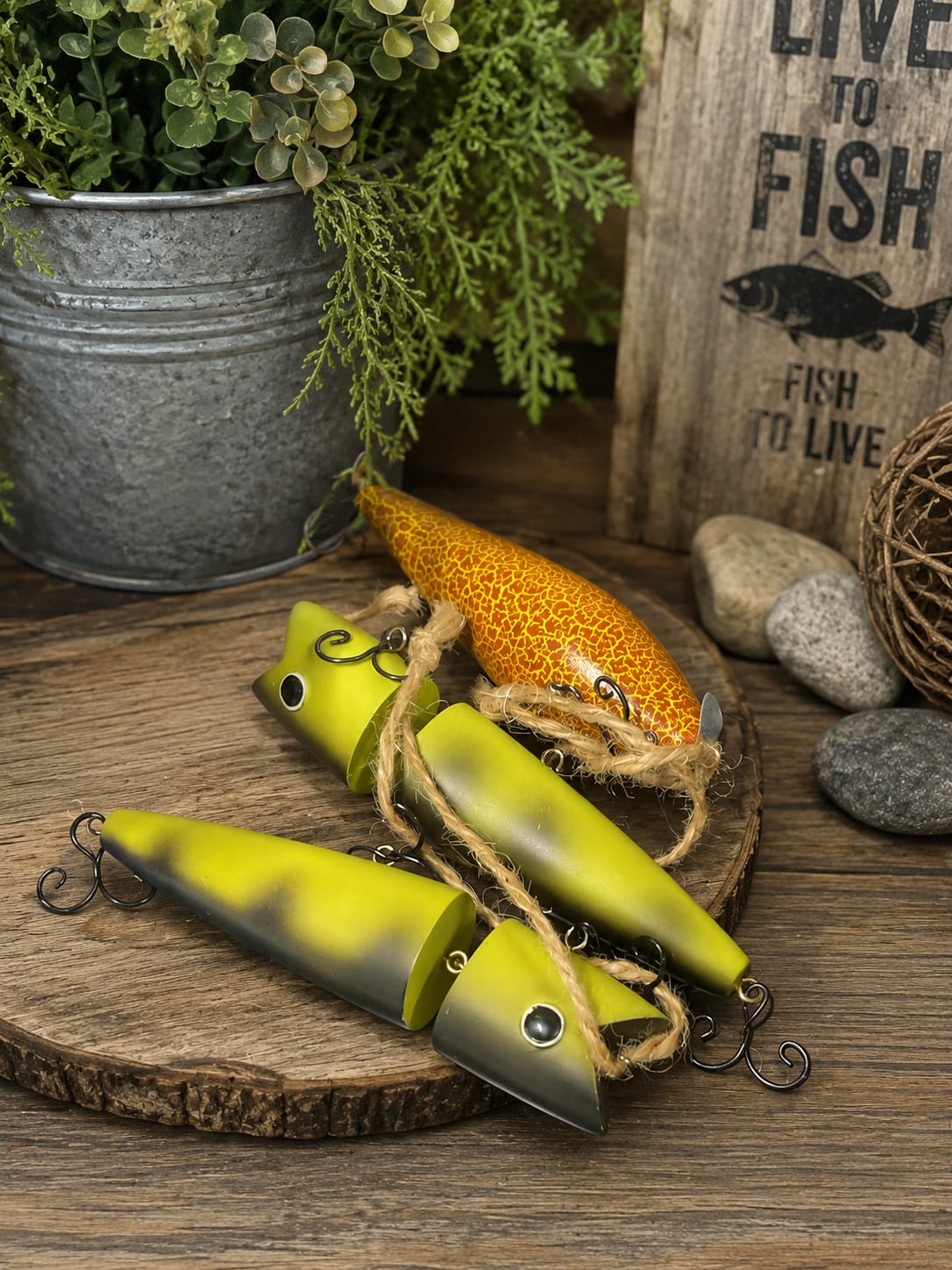 ADD ON Reel Treasures 5” Lures  - Sold separately. Reel Treasures features a decorative 5-inch vintage-style fishing lure designed to add rustic charm and fishing nostalgia to floral gifts, dish gardens, blooming plants, planters, and keepsake displays. Inspired by classic tackle box treasures, these decorative lures make a unique accent for fishermen, anglers, outdoor enthusiasts, and anyone who enjoys life on the water.  Perfect for Father’s Day, retirement celebrations, birthdays, memorial tributes, sympathy gifts, cabin décor, lake house decorating, man caves, fishing-themed displays, and custom floral arrangements. Their realistic vintage appearance makes them an eye-catching addition to dish gardens, green plants, blooming baskets, fresh flower arrangements, and keepsake gifts designed for men.  Whether tucked into a planter, displayed among houseplants, added to a memorial arrangement, or incorporated into a custom gift basket, Reel Treasures brings personality, storytelling, and outdoor character to the design. These decorative lures are intended for display purposes and are not functional fishing tackle.  Each lure measures approximately 5 inches long and is sold individually. Styles, colors, and finishes may vary, making each Reel Treasures accent a unique addition to your gift, arrangement, or decorative display. Perfect for celebrating a favorite hobby, honoring a lifelong fisherman, or adding a touch of rustic fishing tradition to any setting. 