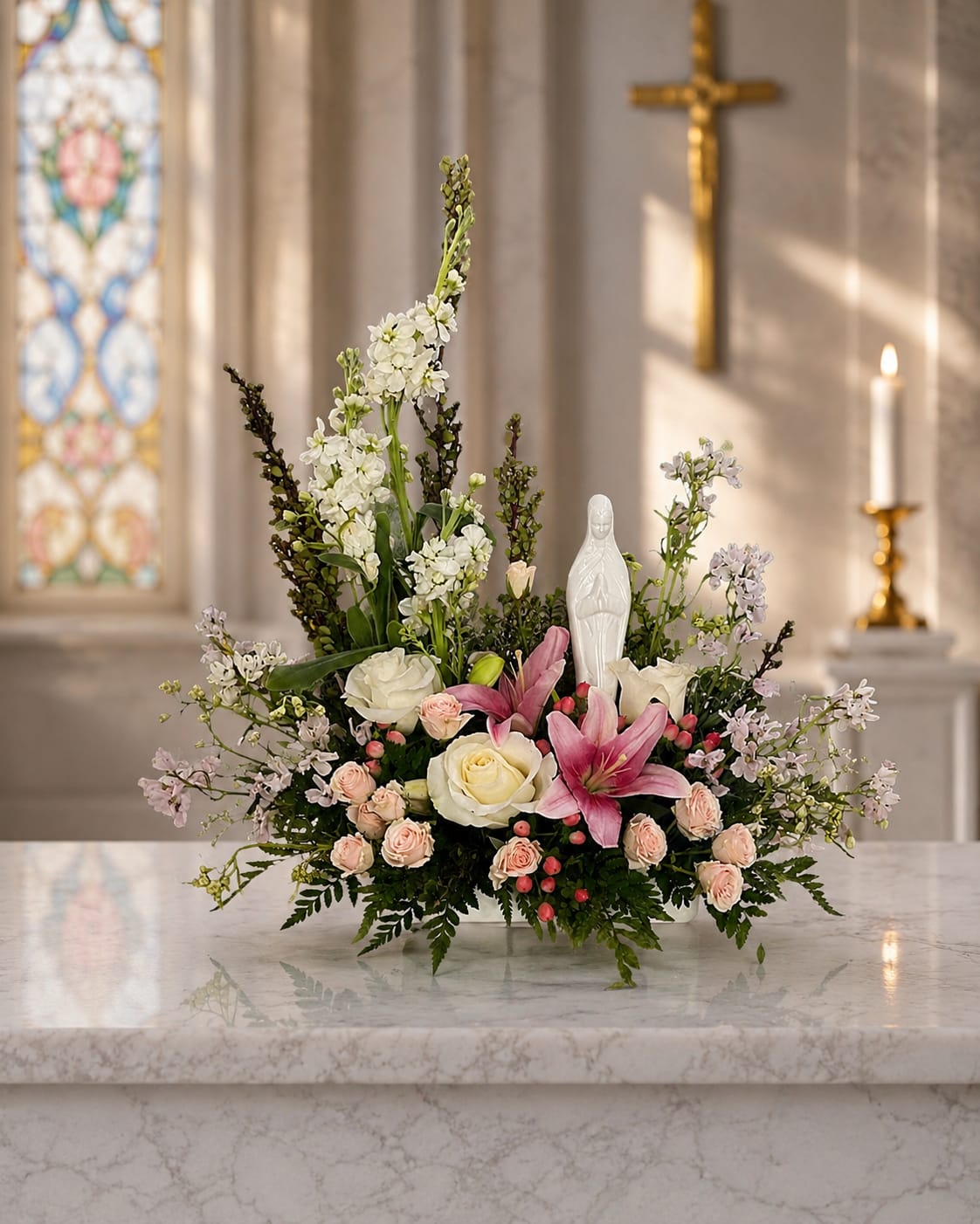 Madonna’s Embrace - Faith, love, and comfort come together in Madonna’s Embrace, a beautiful keepsake arrangement featuring a serene Virgin Mary statue surrounded by fresh flowers in soft, peaceful tones. Designed to inspire hope and offer encouragement, this meaningful gift serves as a lasting reminder of prayer, strength, and God’s enduring presence during life’s most important moments.  Whether sent as a get well gift, thinking of you gesture, encouragement gift, religious keepsake, sympathy tribute, or expression of support, Madonna’s Embrace delivers a message of faith when words are not enough. The graceful presence of the Blessed Mother combined with fresh flowers creates a heartfelt design that brings comfort to homes, hospitals, churches, memorial services, and special occasions alike.  Perfect for Catholic families, religious celebrations, recovery and healing, bereavement, encouragement, or simply letting someone know they are loved and remembered in prayer, this inspirational arrangement offers beauty that speaks to the heart. Designed and delivered with care by Aspen Tower Florist, Madonna’s Embrace is available for local flower delivery in Greensburg, Rushville, Batesville, Shelbyville, North Vernon, Hope, Westport, Sunman, Oldenburg, St. Paul, Waldron, Milroy, and surrounding Indiana communities.  When faith leads the way, Madonna’s Embrace offers a meaningful expression of comfort, hope, prayer, and love that will be treasured long after the flowers have faded.