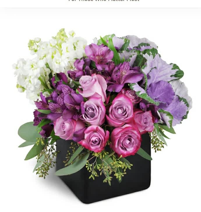 Pink and purple roses with white blooms in a black box