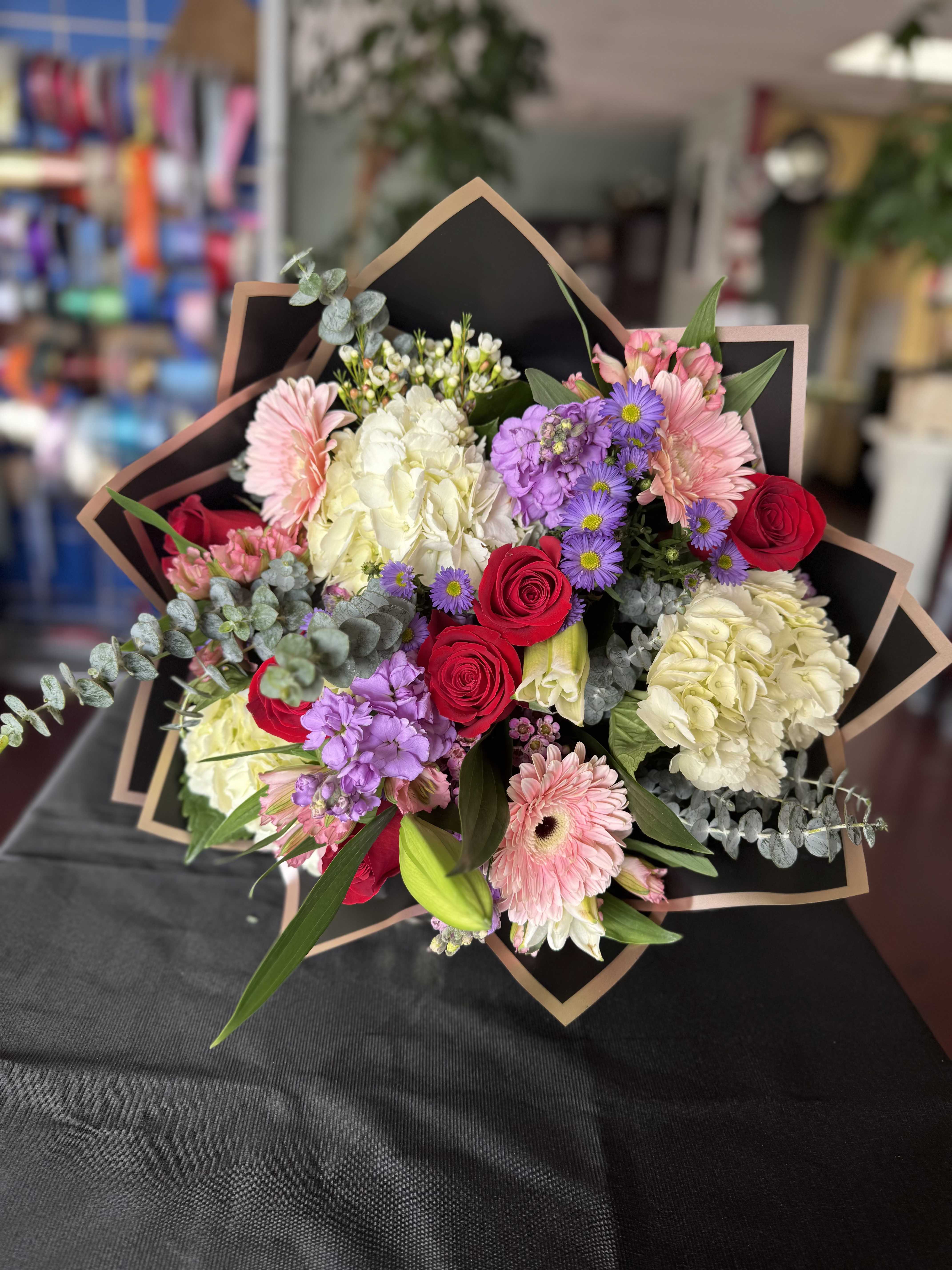 Bouquet of red roses, pink gerberas, and white hydrangeas