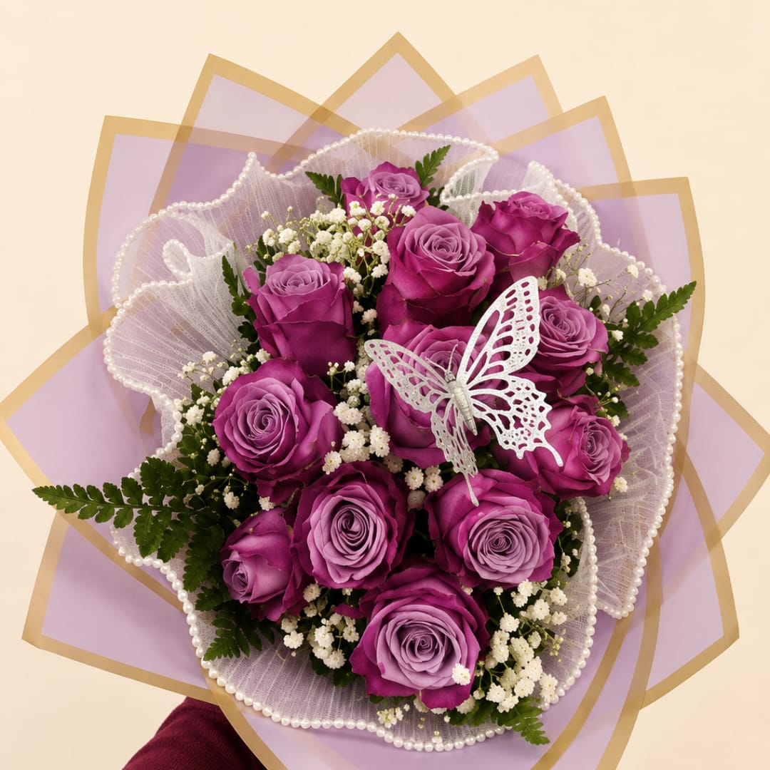 Bouquet of purple roses with white filler flowers and a butterfly decoration