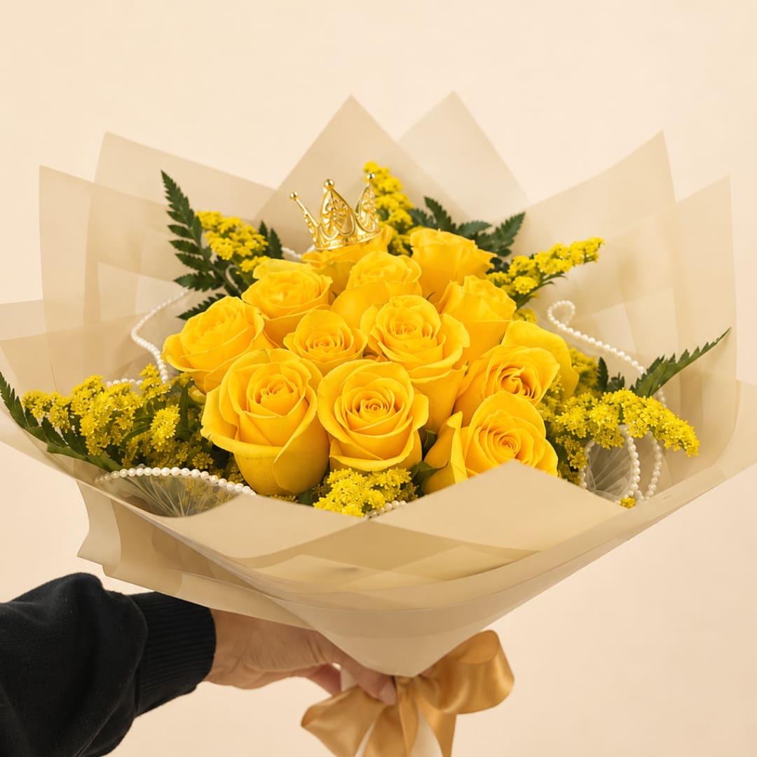 Yellow rose bouquet with a small gold crown topper