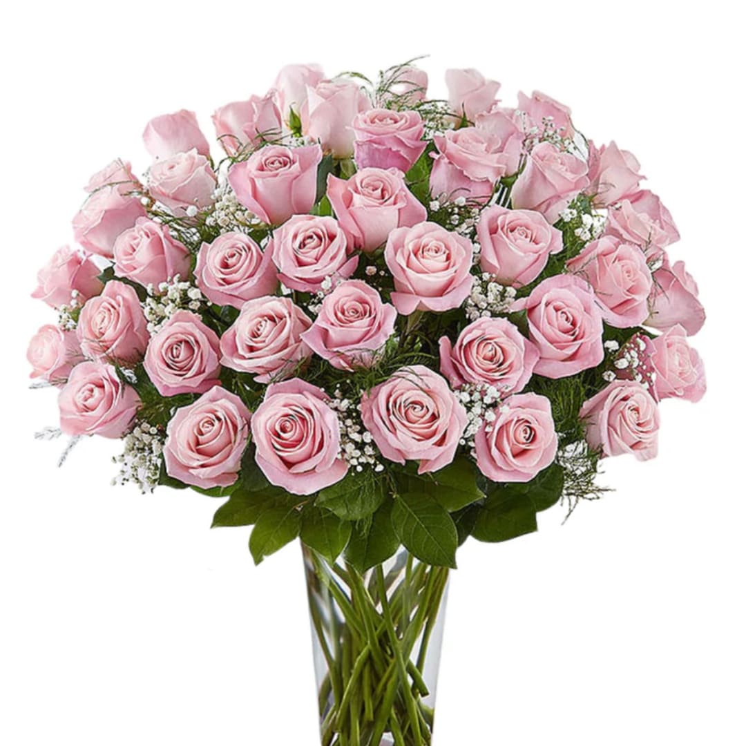 Pink roses arranged in a clear glass vase