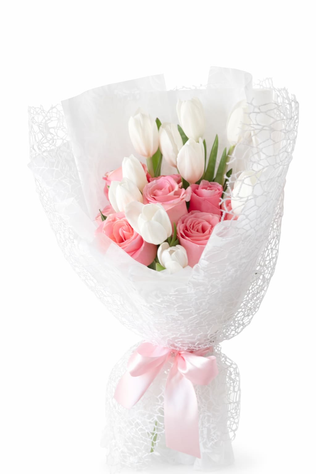 Pink roses and white tulips wrapped in white mesh with a pink ribbon