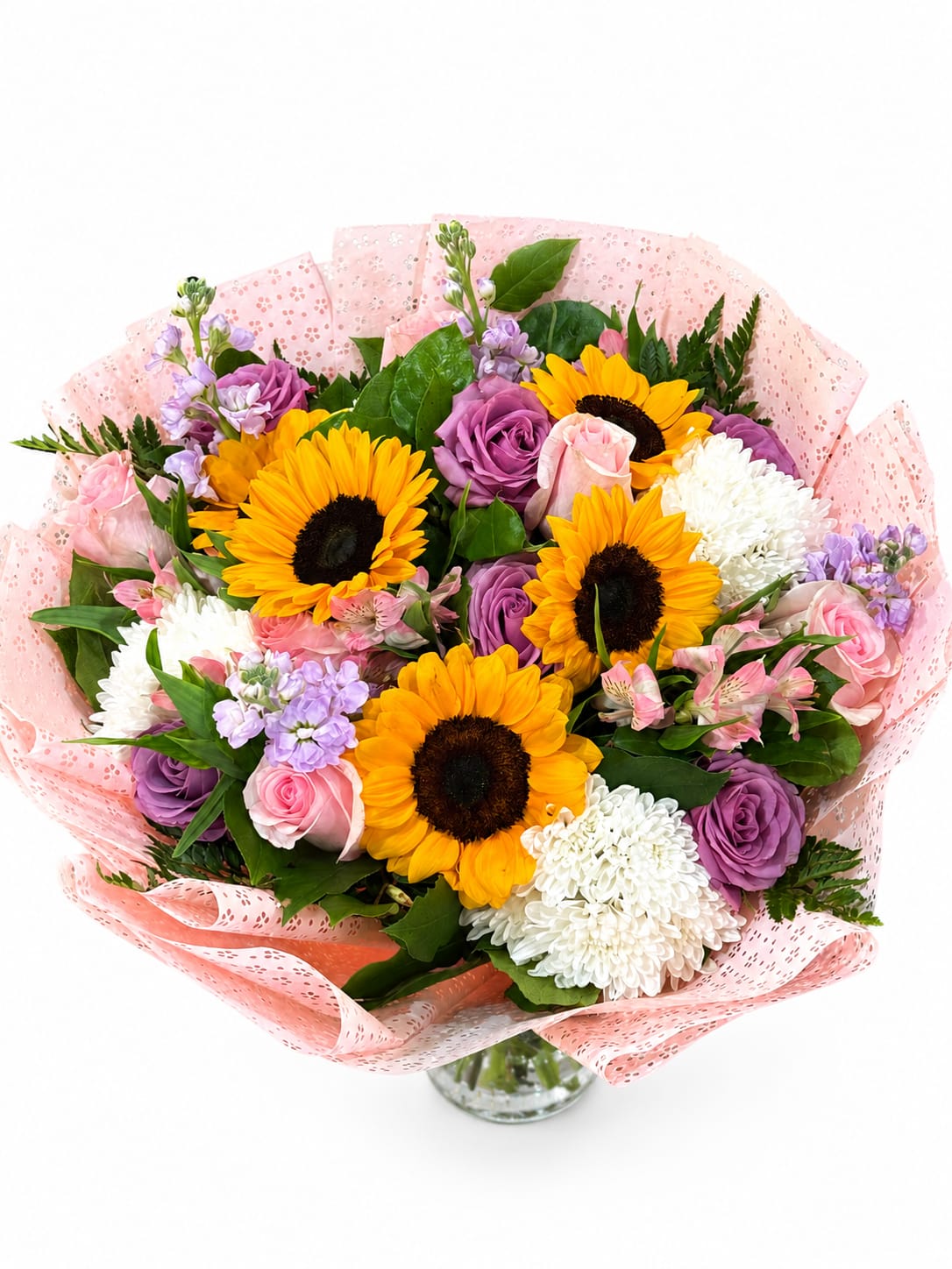 Sunshine Delight - A cheerful hand-tied bouquet featuring radiant sunflowers, lavender roses, blush pink roses, white chrysanthemums, soft lavender stock, and delicate alstroemeria, beautifully wrapped in blush pink paper. Perfect for birthdays, celebrations, thank-you gifts, or simply brightening someone’s day.