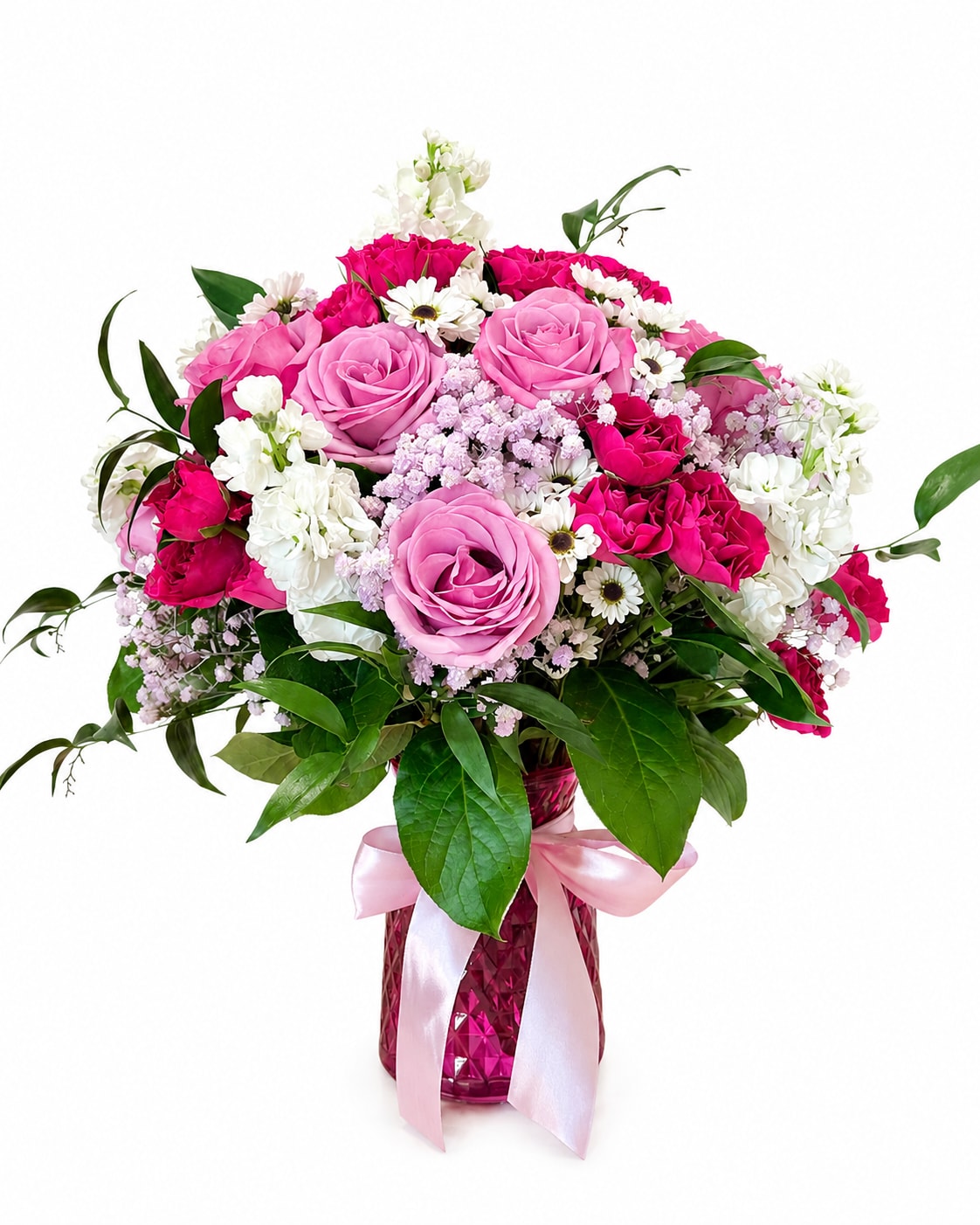 Lavender Delight  - A beautiful arrangement of premium purple roses, vibrant hot pink spray roses, white stock, delicate daisy accents, and lush greenery, elegantly arranged in a keepsake pink vase with a satin ribbon. Perfect for birthdays, anniversaries, or any special occasion