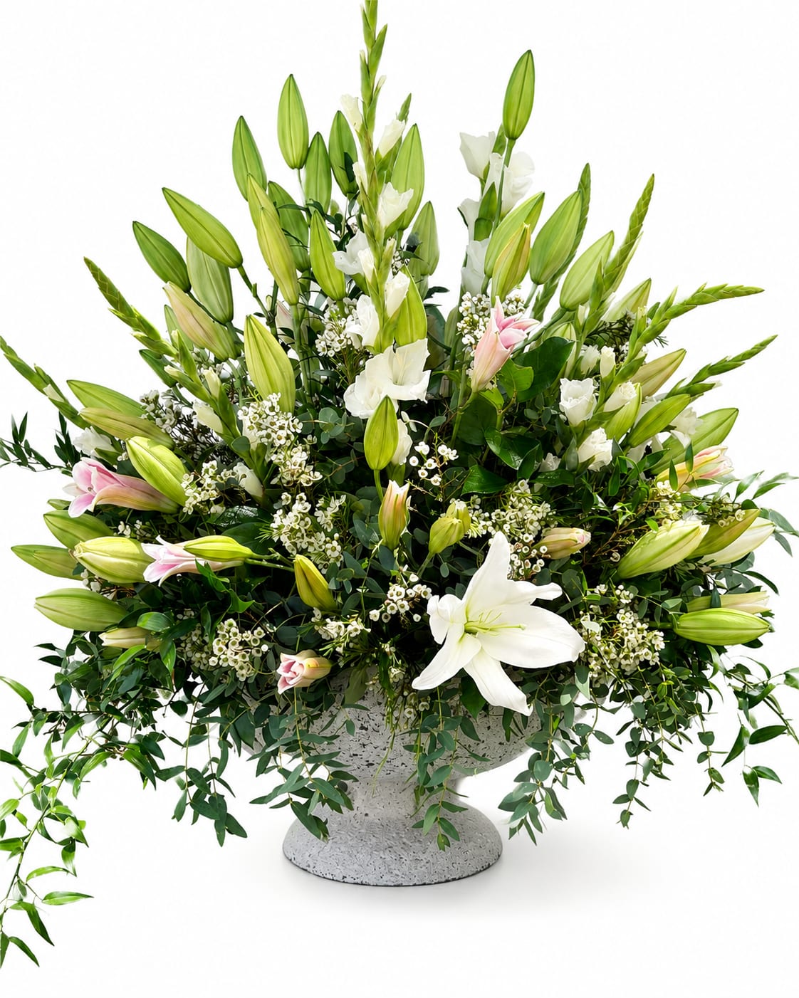 Lily Luxe - A lush arrangement of Oriental lilies, gladiolus, waxflower, and cascading greenery, beautifully designed in a textured cement vase for a timeless and elegant statement.