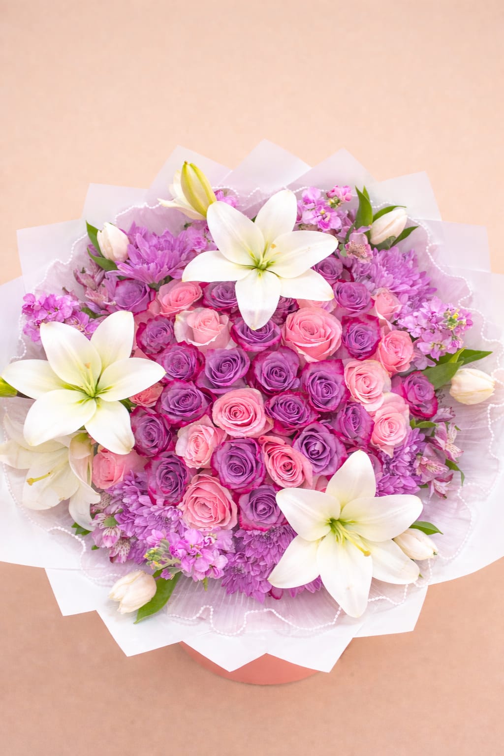 Lavander Luxe Bouquet  - A luxury and romantic floral arrangement, featuring 50 premium roses in shades of Lavender and pink. Beautiful accented with fresh white Lilies, tulips, and season blooms. Perfect for Birthday celebration or a just because 