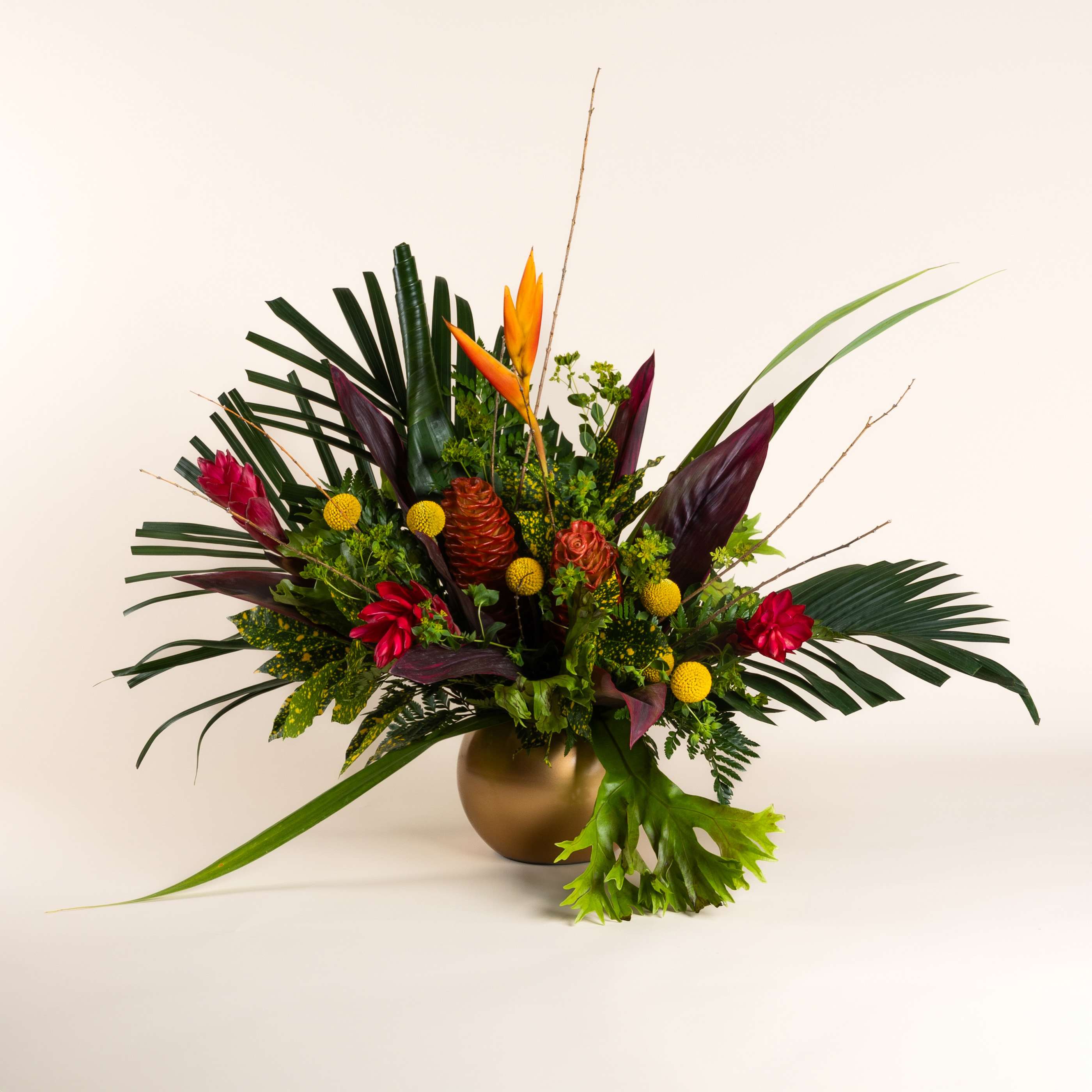 Paradise Bouquet  - Red ginger, bird of paradise, yellow Billy balls, and shampoo ginger with assorted tropical greens designed in a gold bubble bowl.