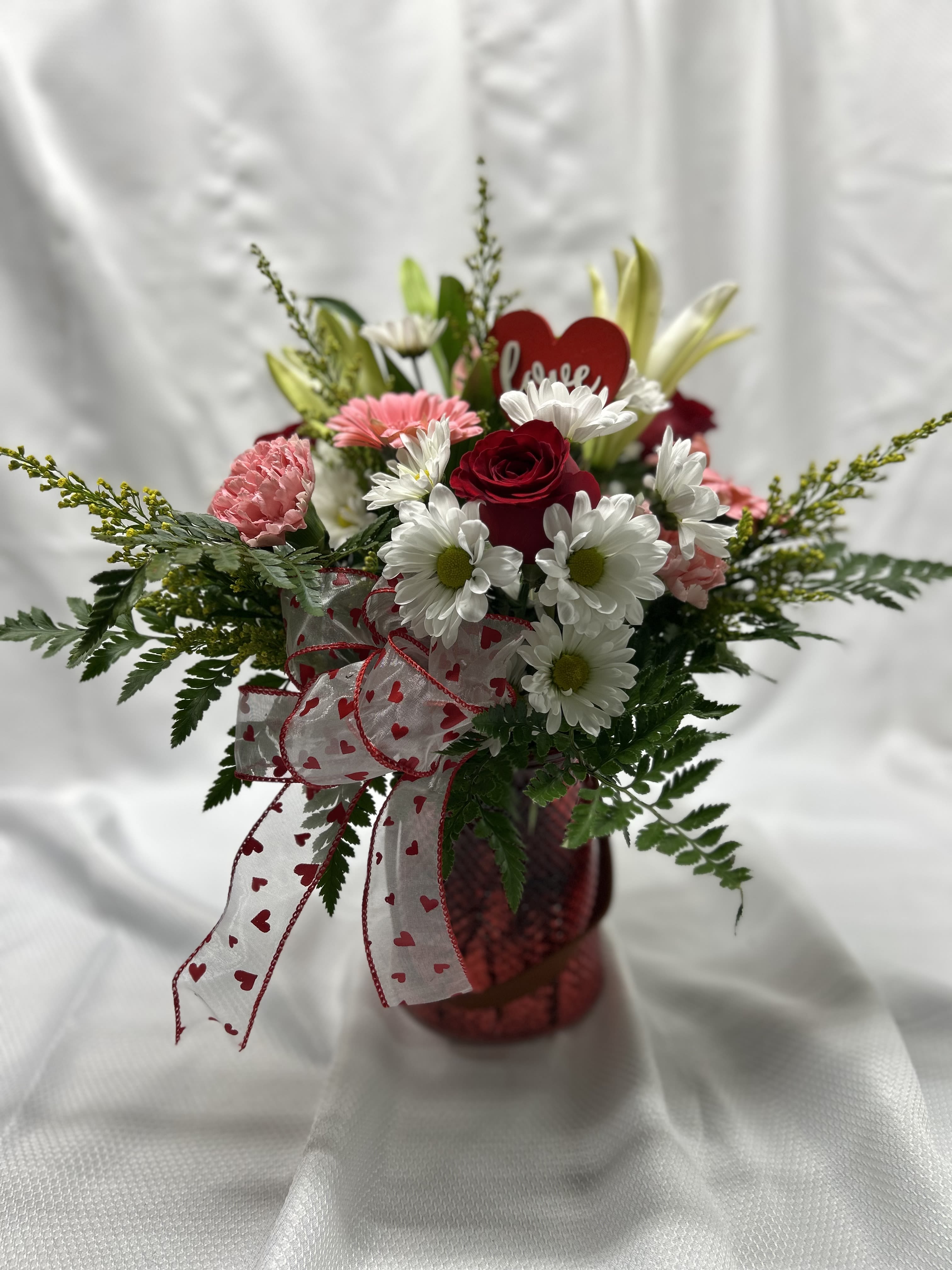 Pookie - Pink carnations, pink mini gerberas, white daisies, white lily red roses, &amp; solidego