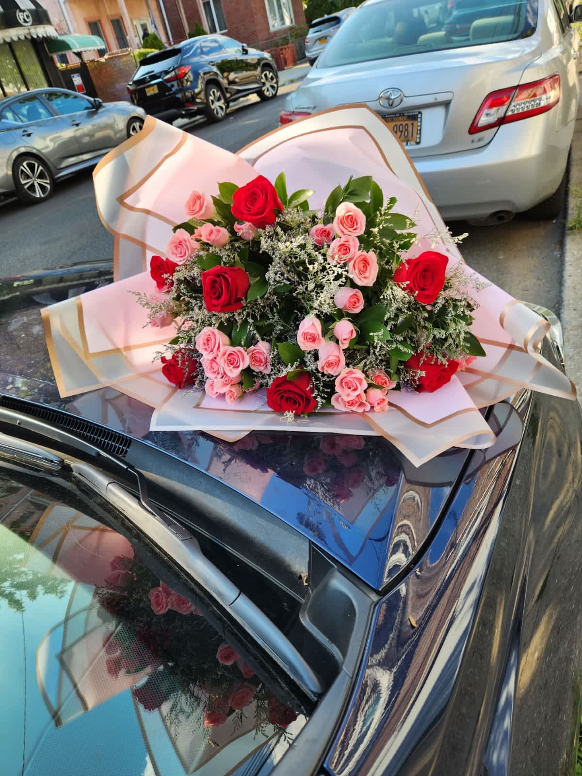 Red Roses With Pink Spray Roses - Due to current supply shortages, some substitutions of flowers and containers (hat box/vase) may be required. We will ensure that the overall look and feel of the gift you selected is preserved. All upgrade arrangements come without a vase - if you wish to purchase one please call us at (347) 492-5777. Thank you for your understanding and support.