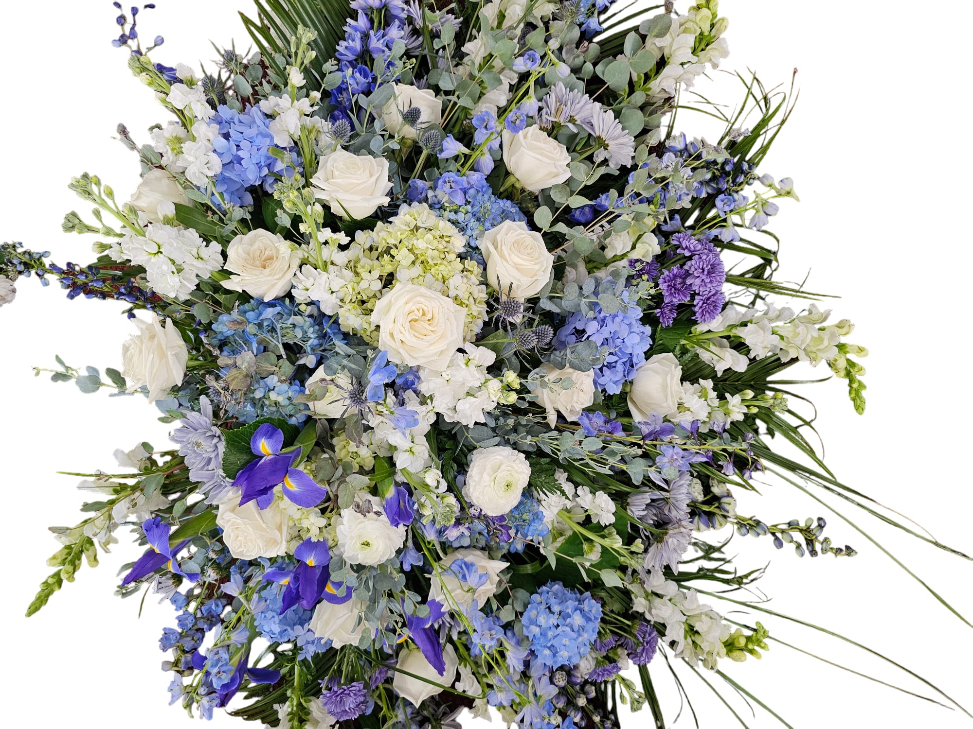 Large bouquet of white roses, blue hydrangeas, and purple flowers