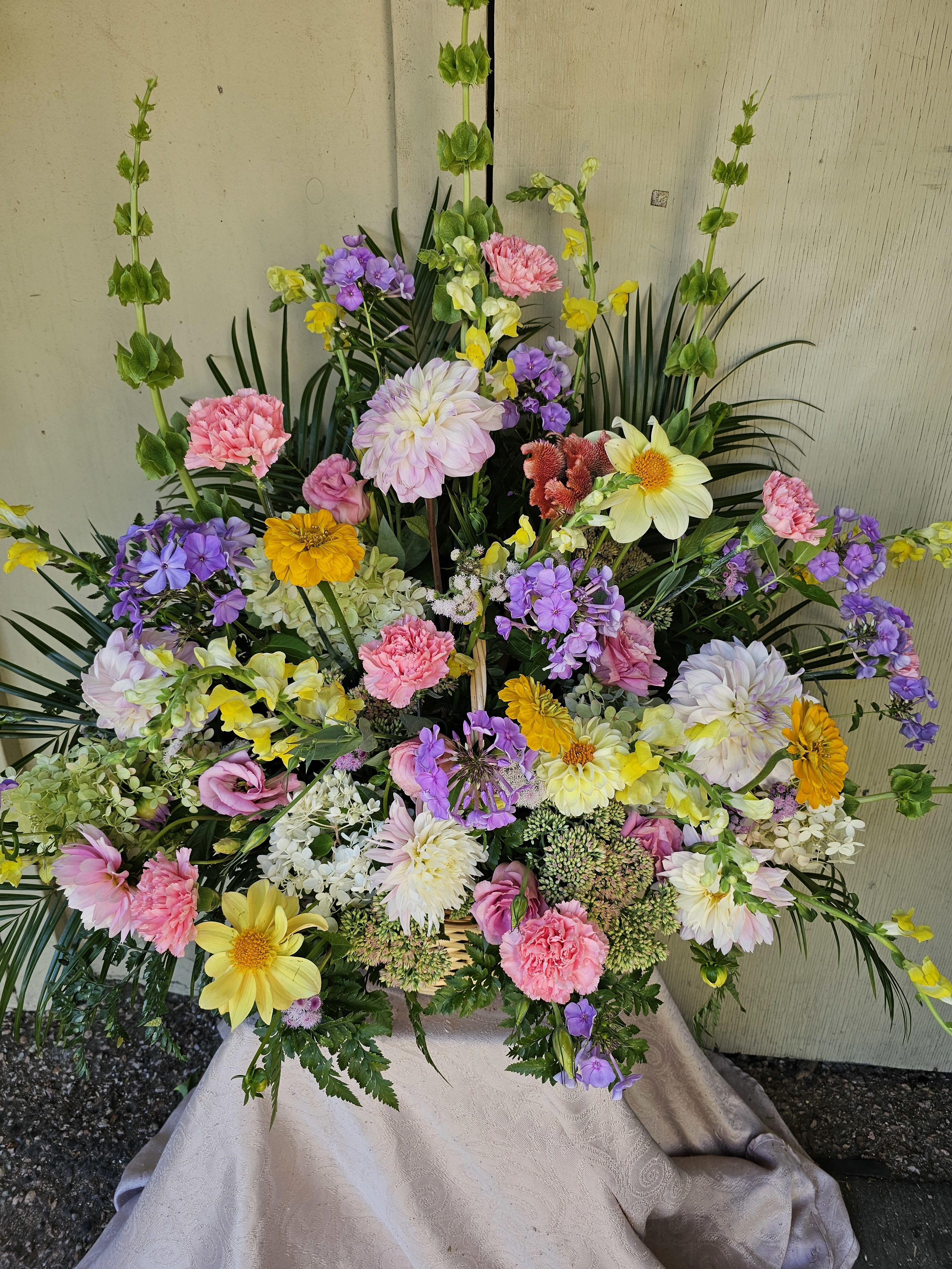 Large mixed floral spray with pink, yellow, purple, and white blooms