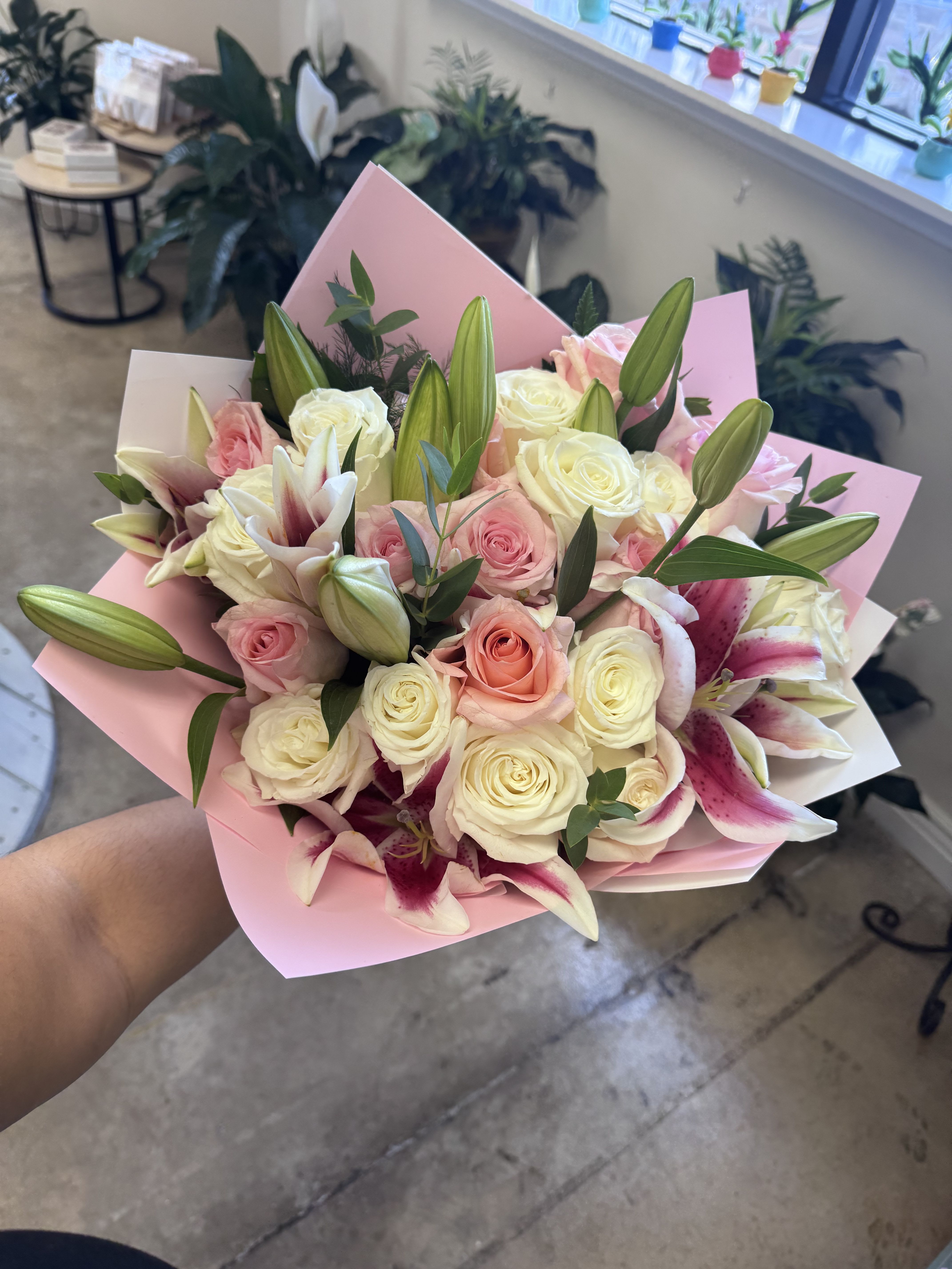 Wrapped in love  - A lush wrap of one dozen pink roses, one dozen white roses &amp; stargazer lilies. Make mom feel truly celebrated. 