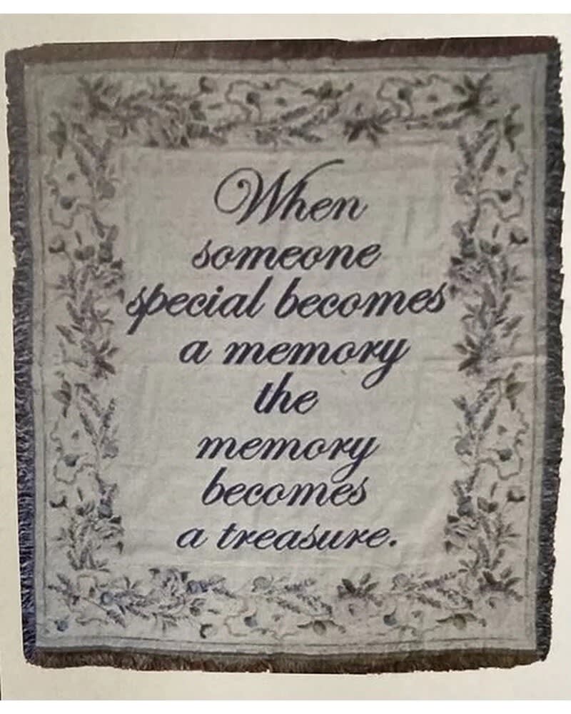 Decorative memorial throw blanket with a printed quote and floral border