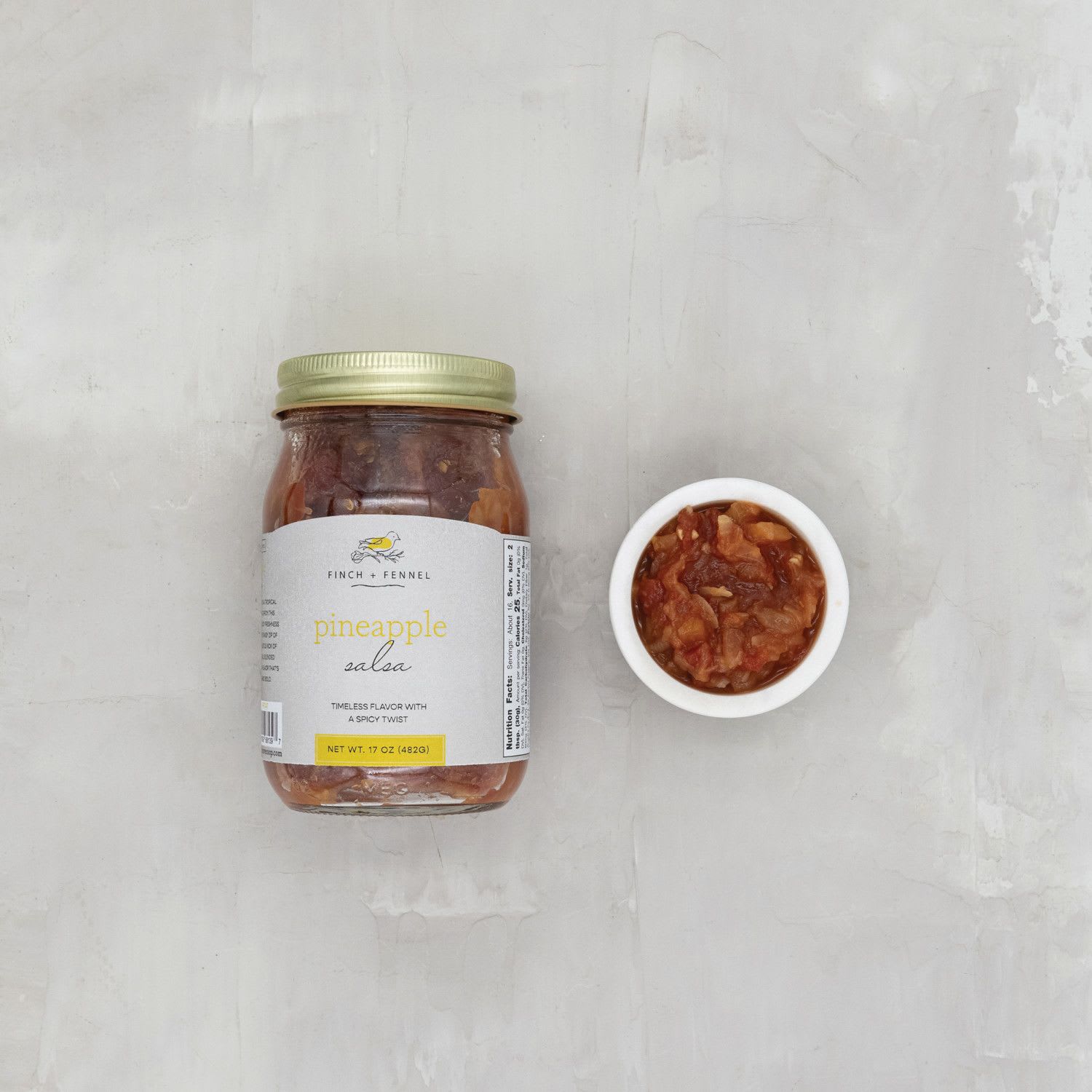 Finch + Fennel 17 oz. Pineapple Salsa - Our Pineapple Salsa is a tropical fusion of sweet and spicy! This salsa combines the juicy freshness of ripe pineapple and the tangy zip of red onion. It’s blended together to create a flavor that’s refreshing and bold.