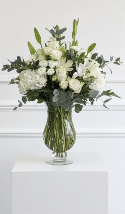 White floral arrangement in a clear glass vase