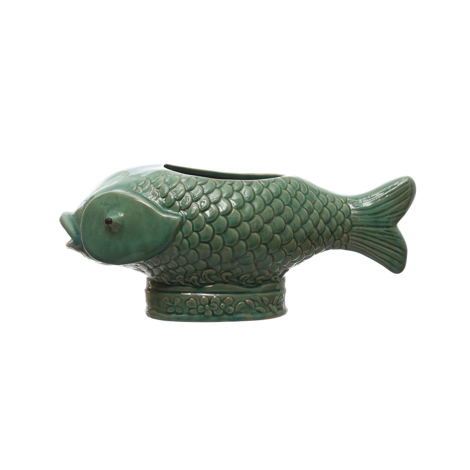 Stoneware Fish Planter - Holds 7" Pot This stoneware fish planter with debossed design and reactive glaze in turquoise is a lovely piece that can brighten up any space. This planter has a fish shape that gives it a whimsical and charming look. The planter has a debossed design on its surface that creates a textured and elegant effect. 