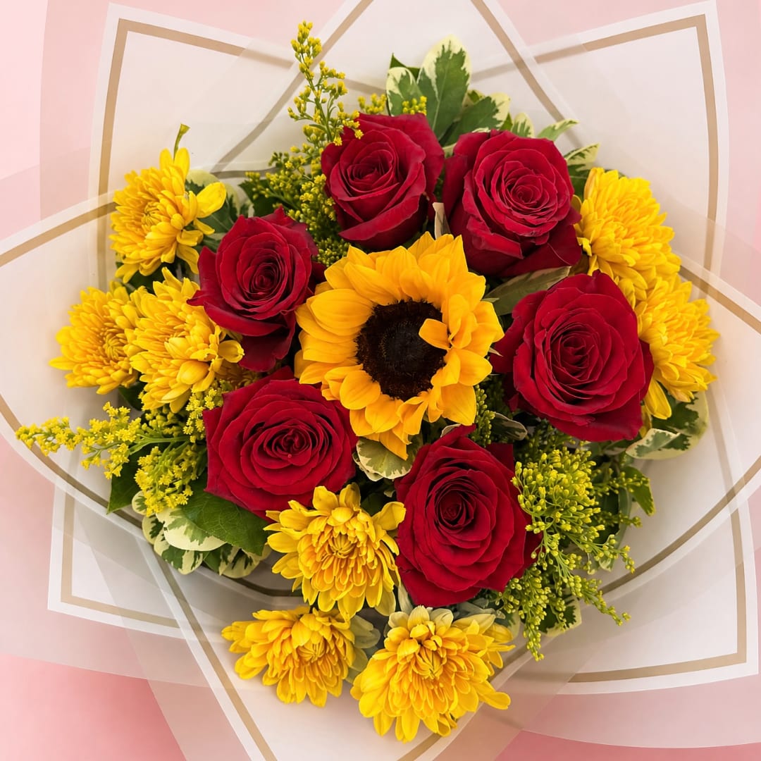 Bouquet of red roses and yellow chrysanthemums with a sunflower center