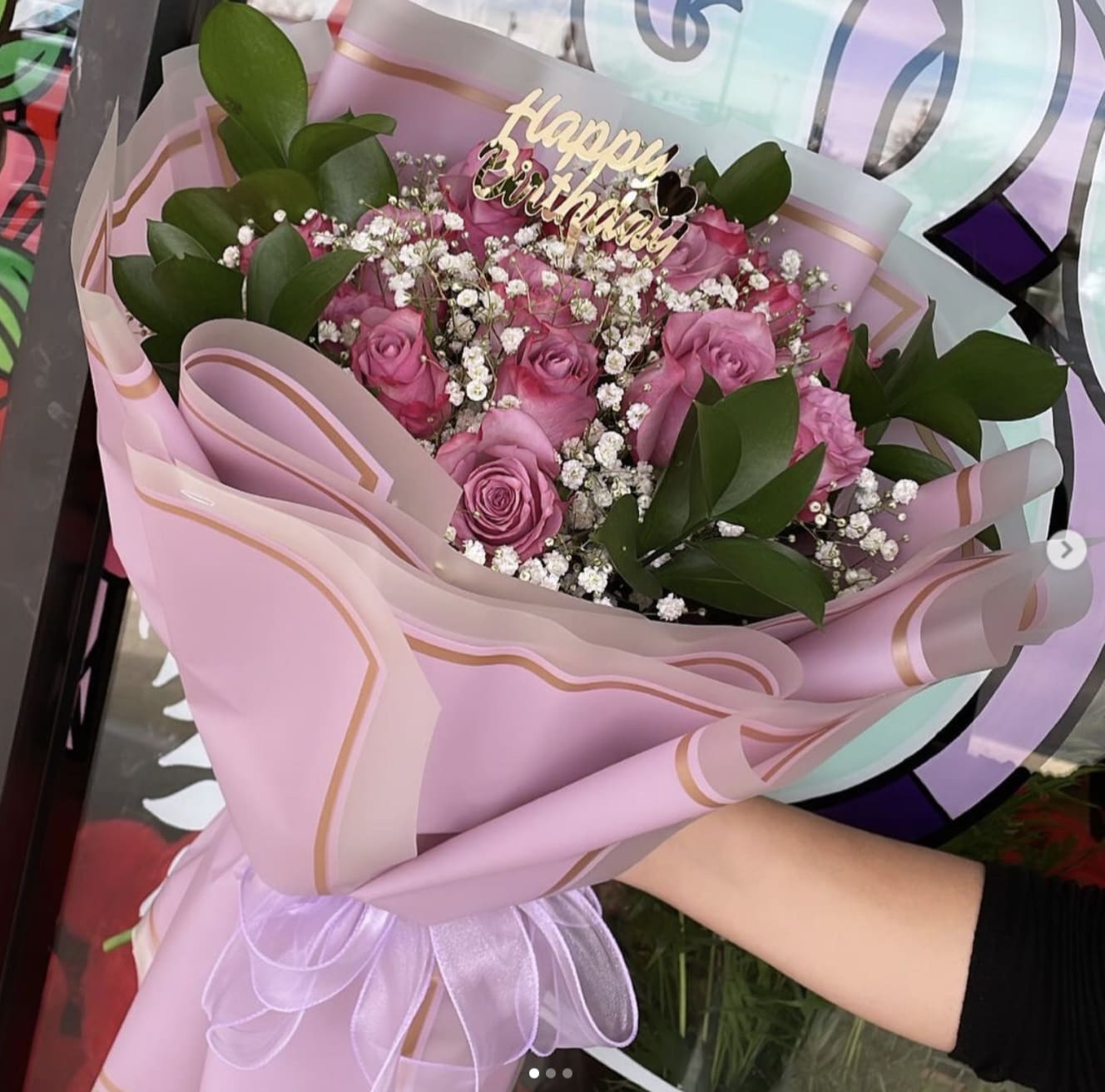 Pink rose bouquet with baby's breath wrapped in pastel pink paper
