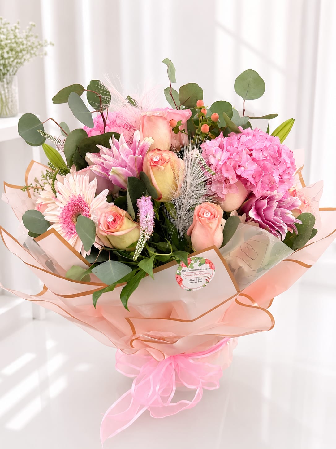 Pink and peach bouquet with roses, hydrangea, and gerbera daisies